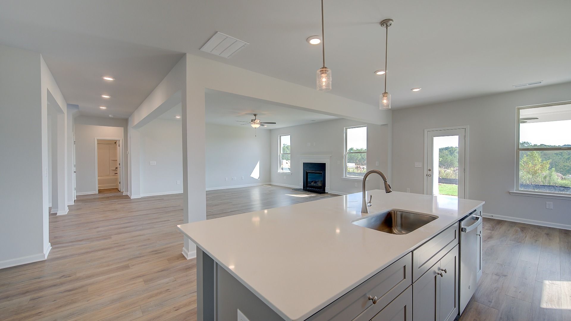 McKinley II open-concept kitchen with large island overlooking breakfast area and family room at Brighton in Locust Grove, GA