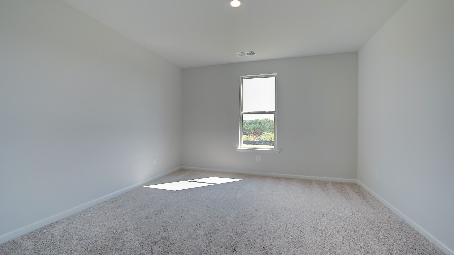 McKinley II secondary bedroom with carpet flooring and natural light at Brighton in Locust Grove, GA.