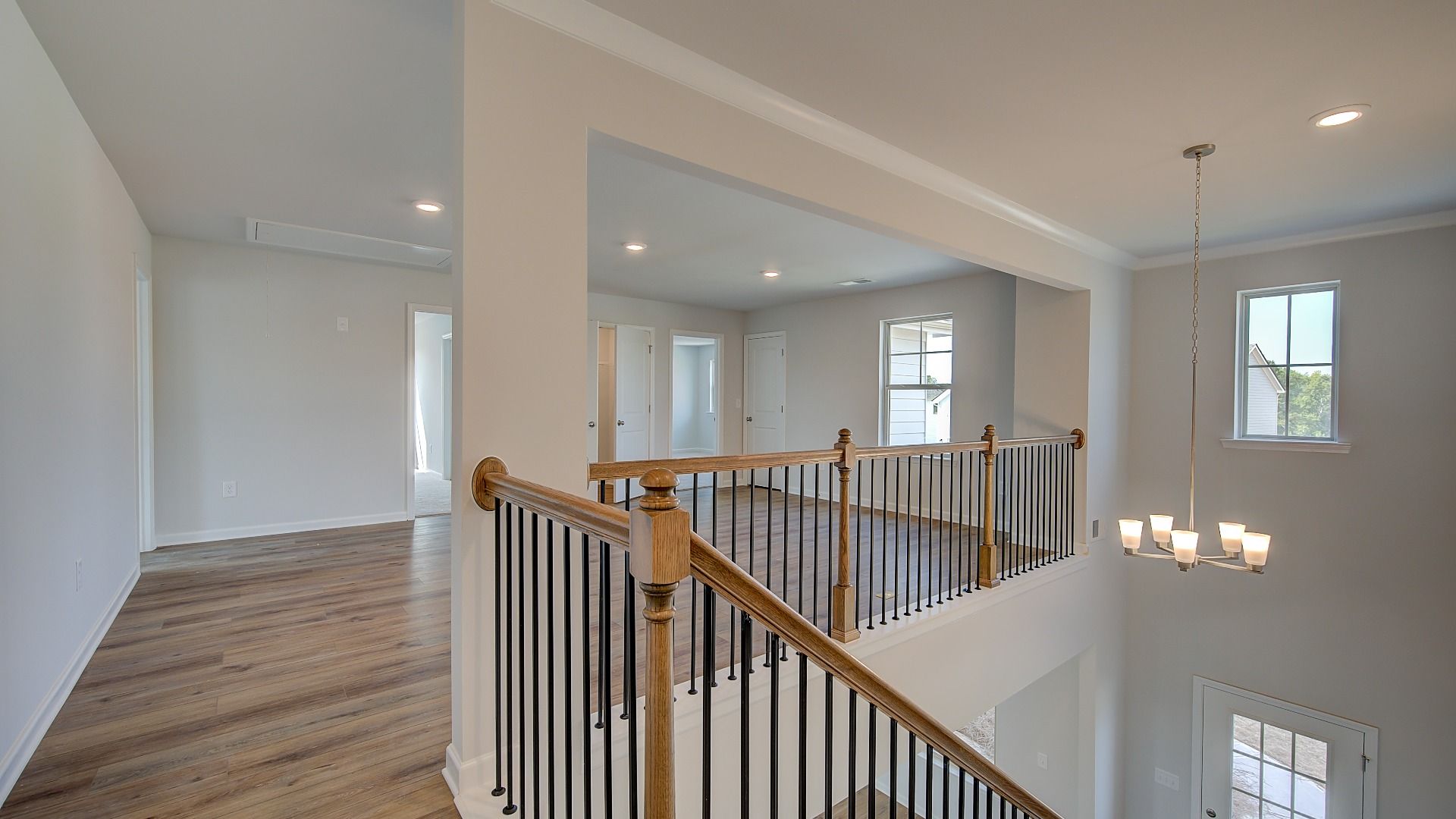 McKinley II upstairs landing with open hallway leading to loft at Brighton in Locust Grove, GA.