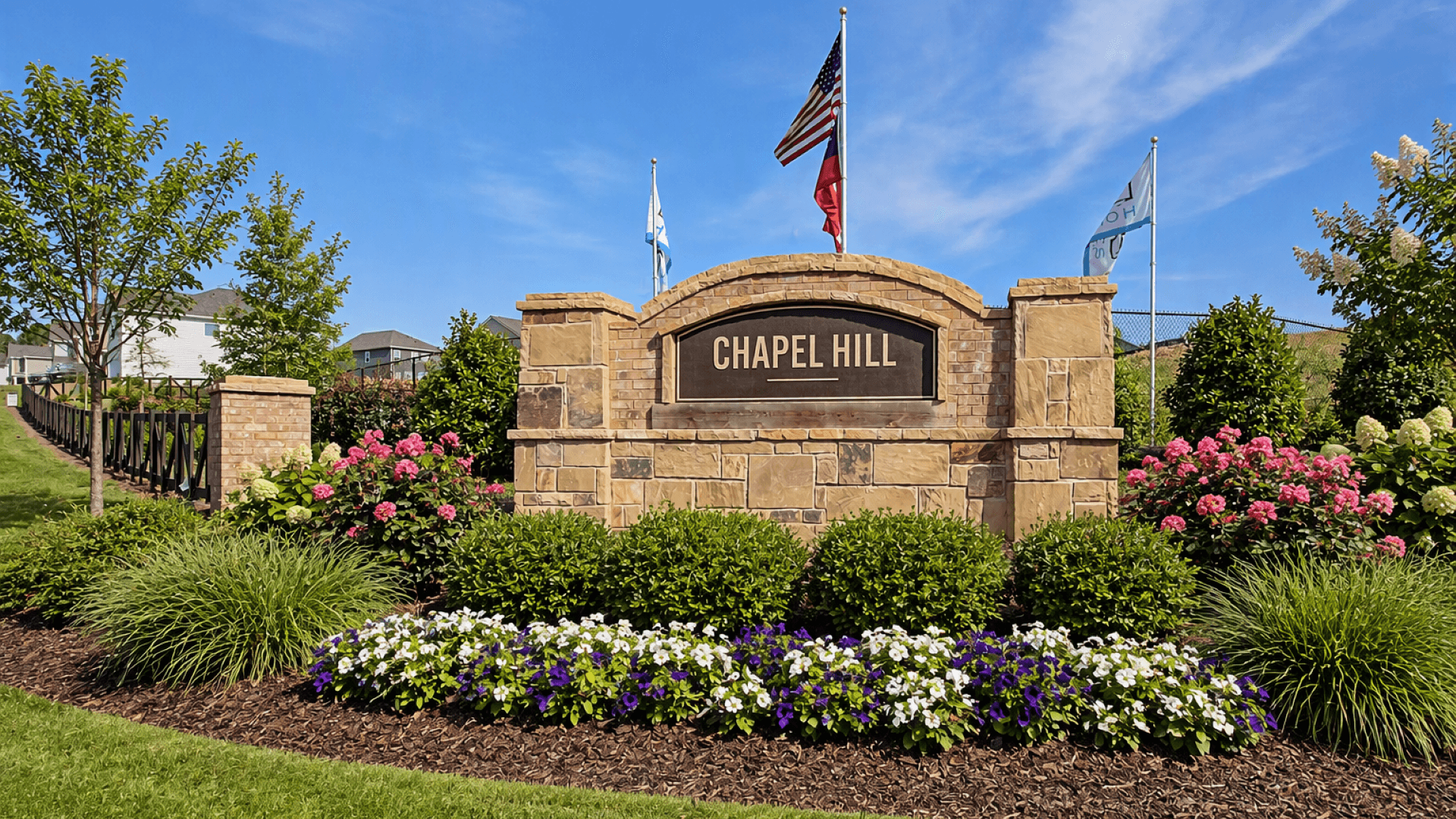 Welcoming entrance with manicured landscaping to Chapel Hill new construction single family home community in Newnan, GA.