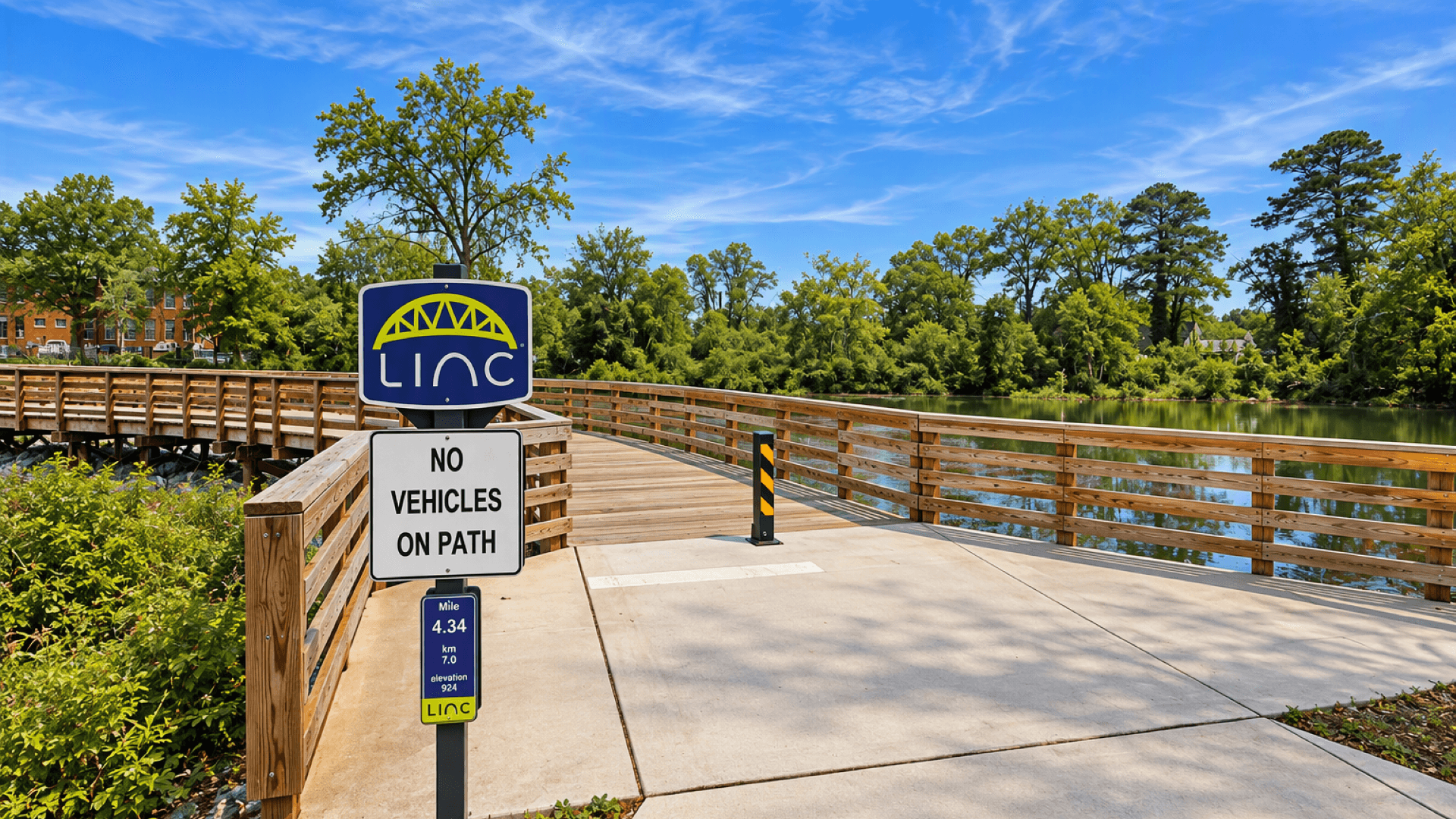 Recreational trail section of The LINC with landscaped greenspace and paved walking path near Chapel Hill in Newnan, GA.