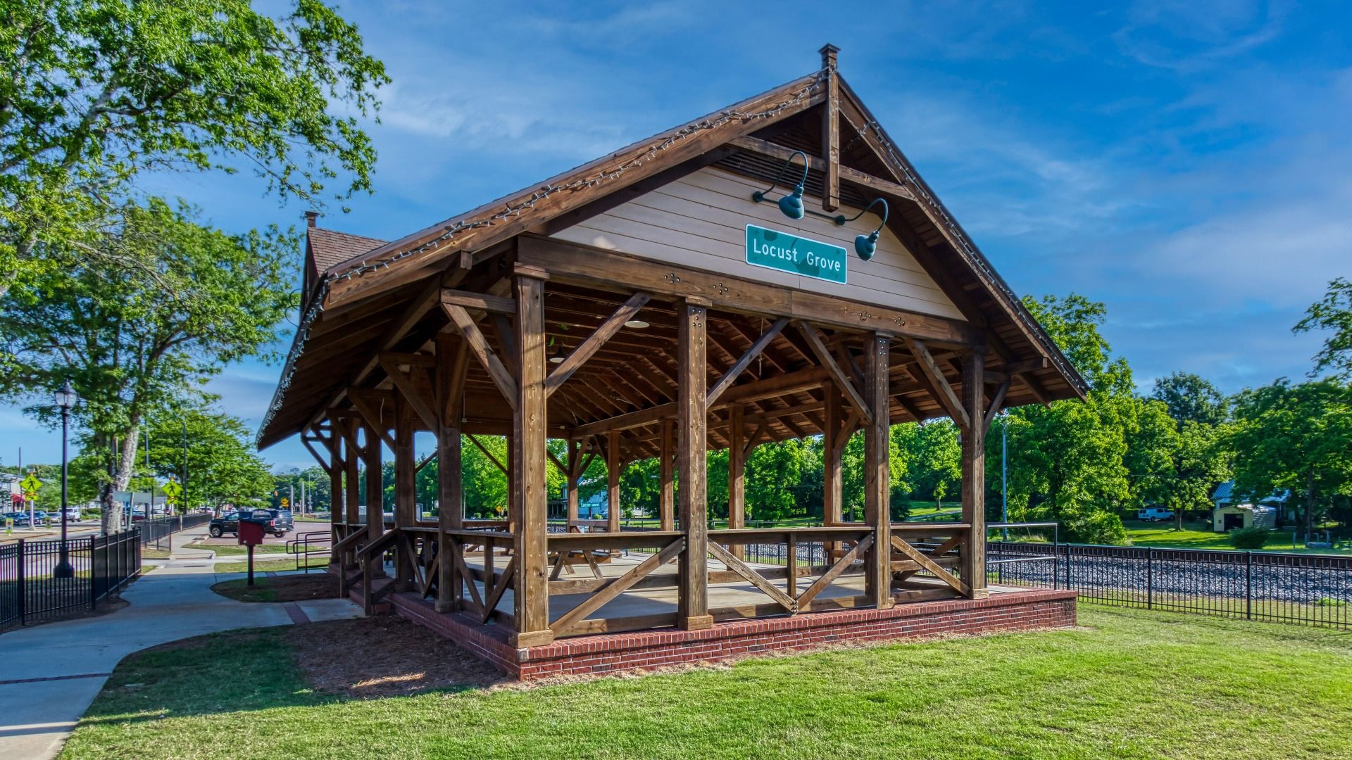 Peaceful Locust Grove pavilion with picnic tables and greenery near Kingston new home community.