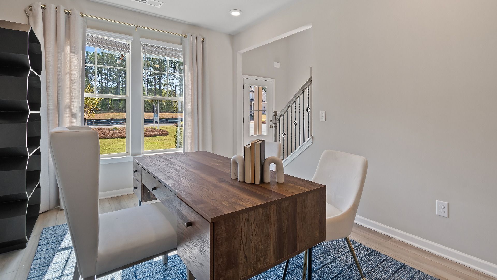 McKinley II living room with flexible home office space, LVP flooring, and natural light at Brighton in Locust Grove, GA.