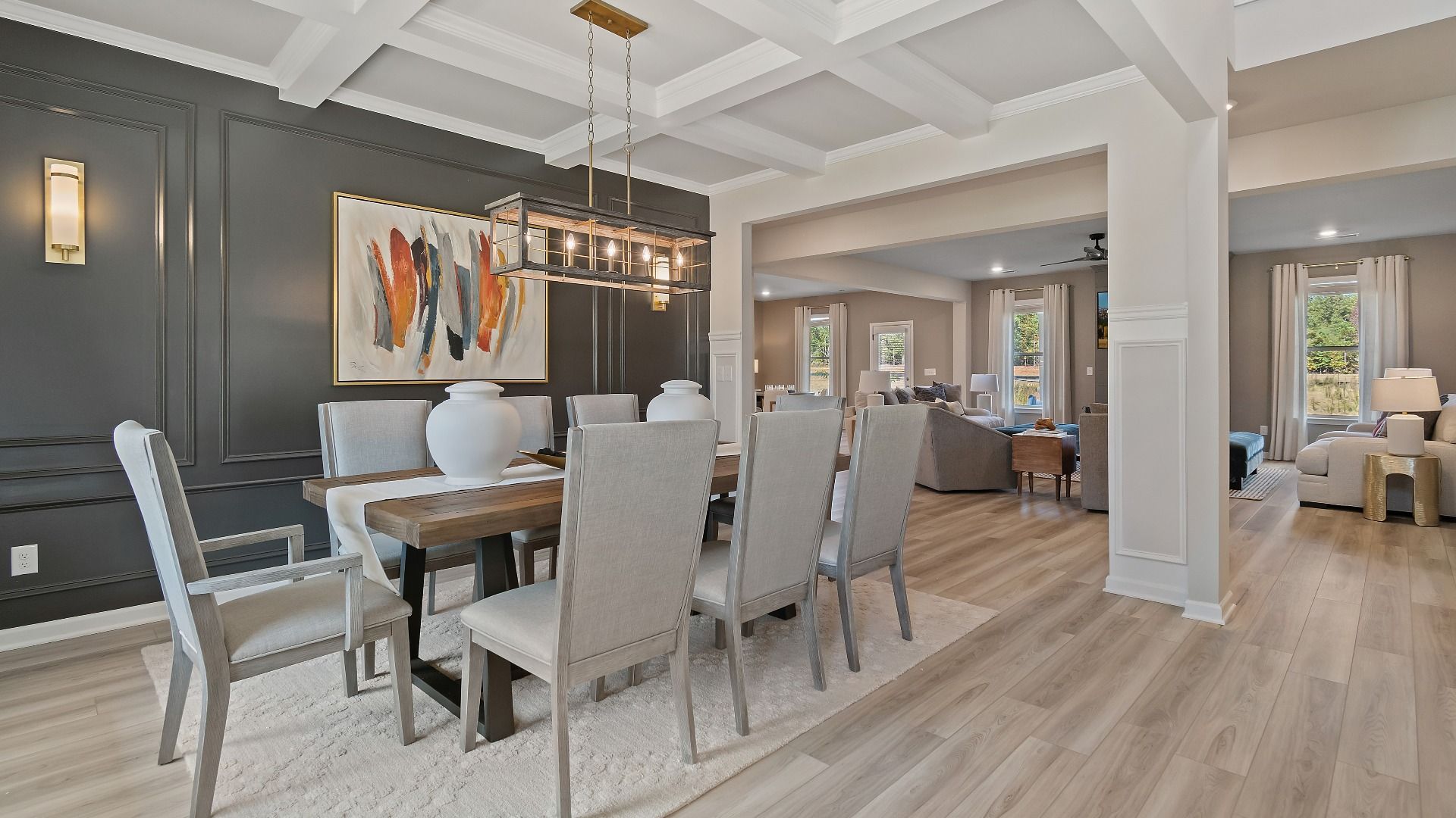 Open dining room with coffered ceiling, spacious seating, and neutral modern finishes in the McKinley II at Brighton.