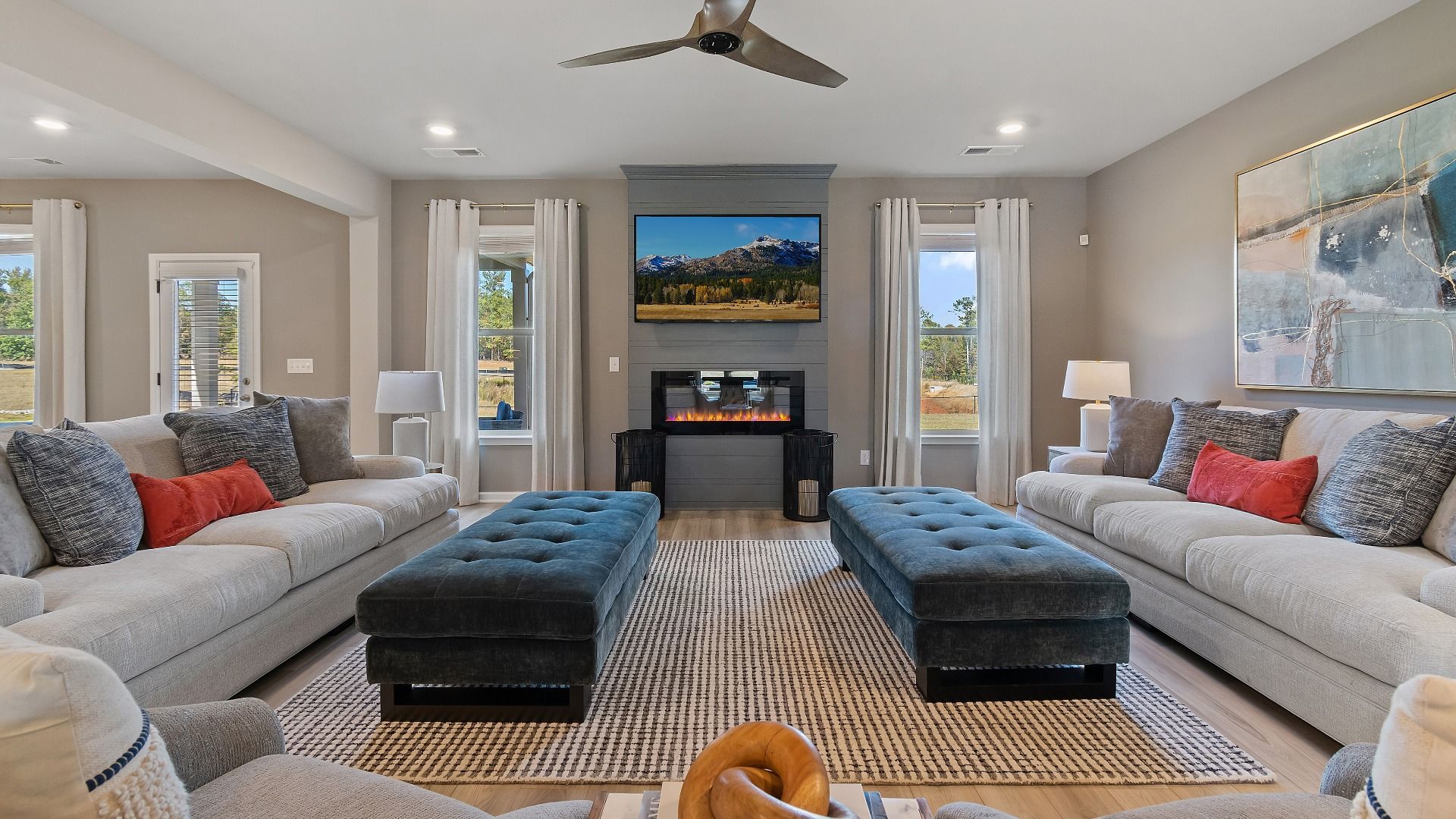 McKinley II bright open-concept family room with electric fireplace, natural light, and abundant seating area at Brighton.