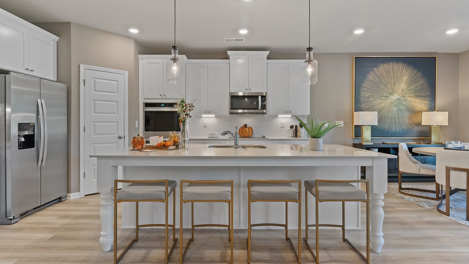 Gourmet kitchen with oversized island, pendant lighting, and white cabinetry in the McKinley II at Brighton.
