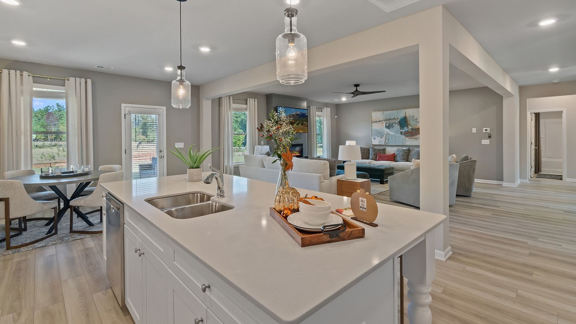 McKinley II open-concept kitchen with large island overlooking breakfast area and family room at Brighton in Locust Grove, GA