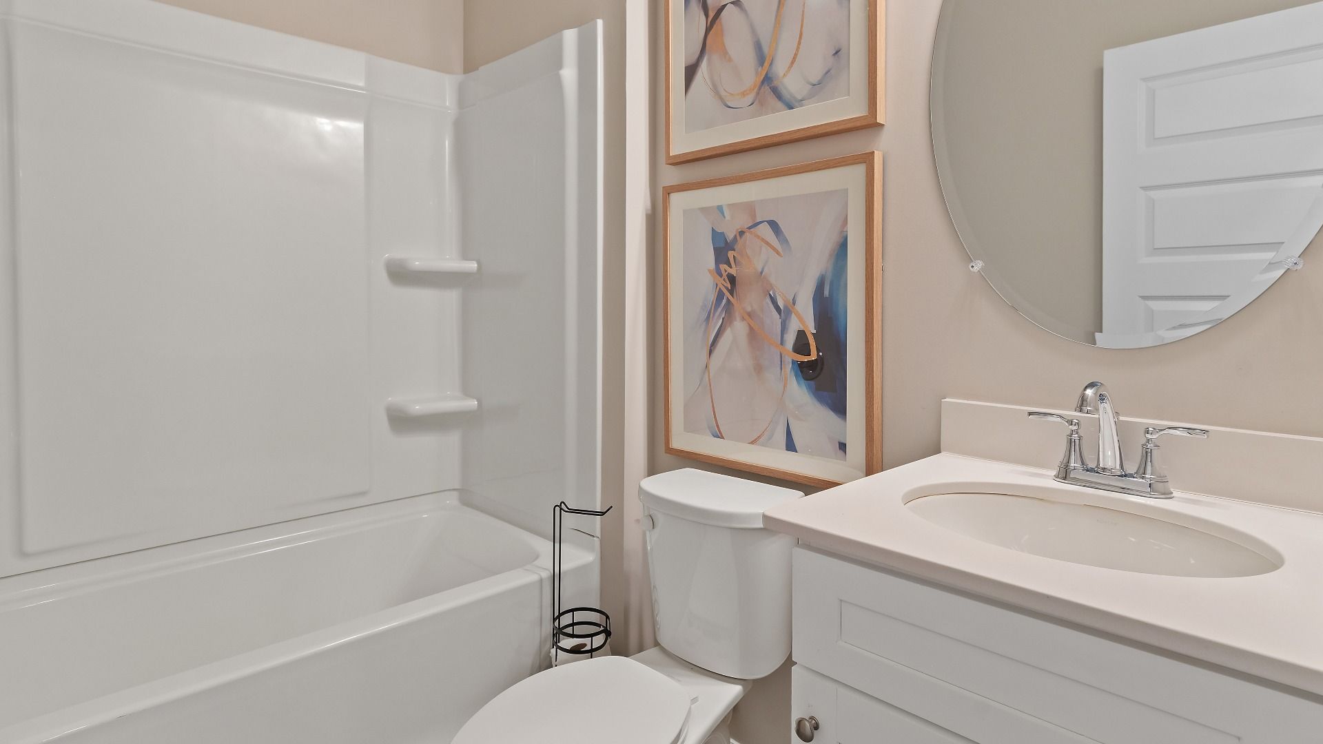 Secondary bath with shower-tub combo, vanity, and neutral finishes in the McKinley II at Brighton in Locust Grove, GA.