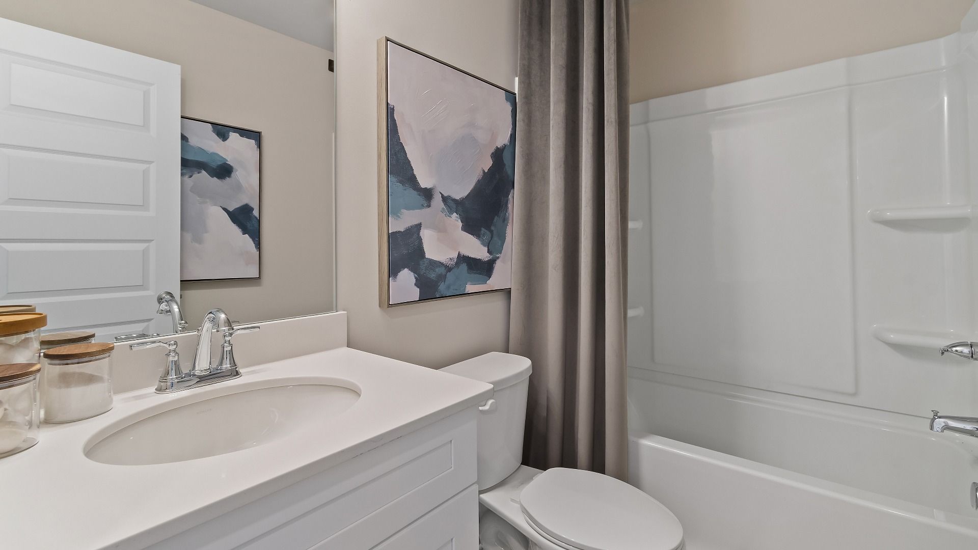 McKinley II bath with shower-tub combo, vanity, and neutral finishes at Brighton in Locust Grove, GA.