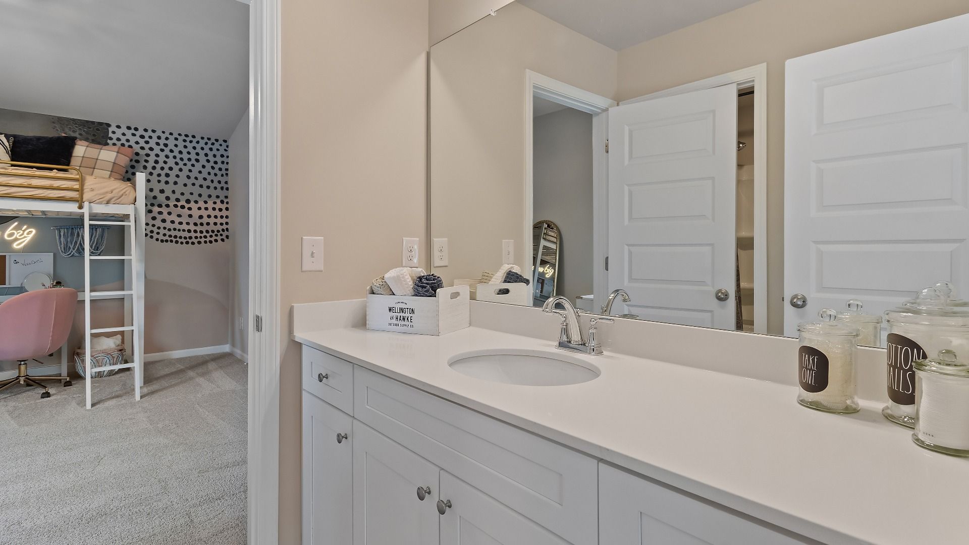 McKinley II secondary bath connected to bedroom with wide vanity and neutral finishes at Brighton in Locust Grove, GA.