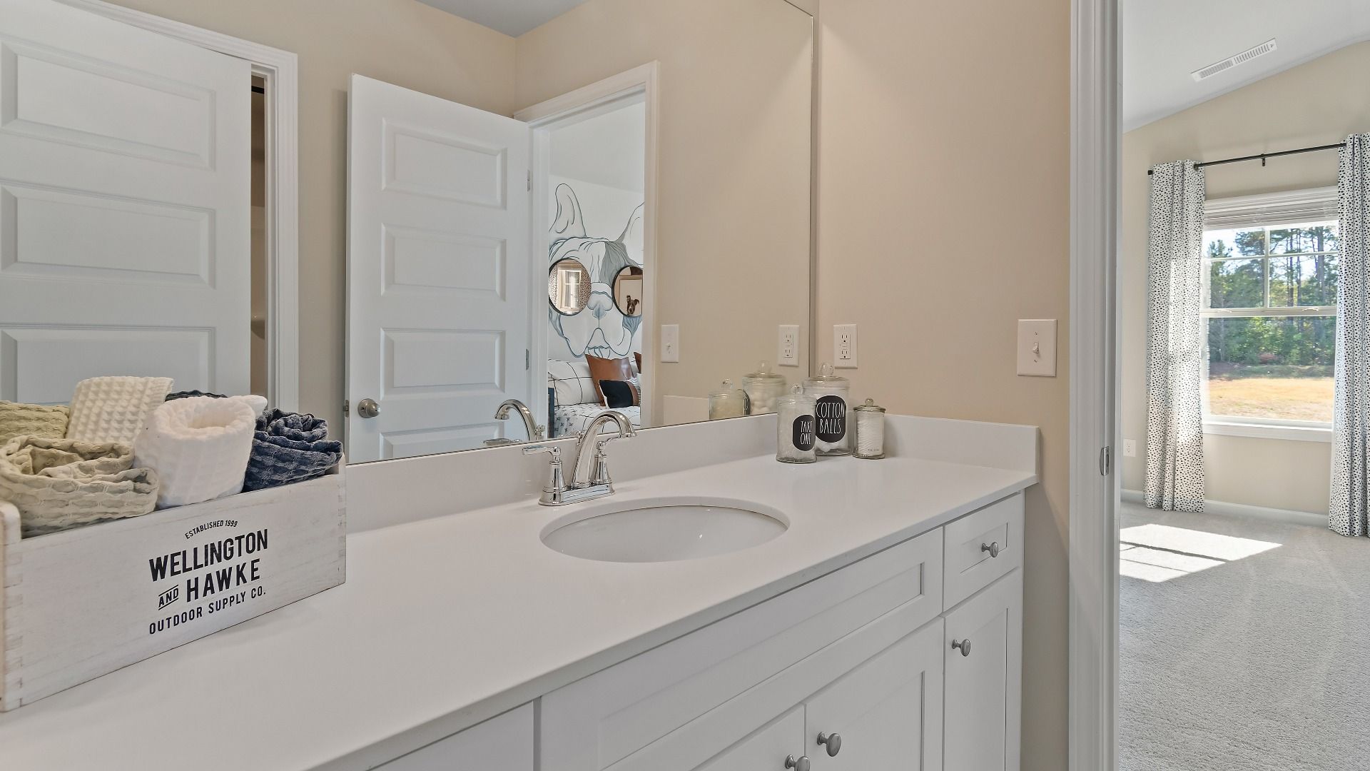 McKinley II secondary bath connected to bedroom with wide vanity and neutral finishes at Brighton in Locust Grove, GA.