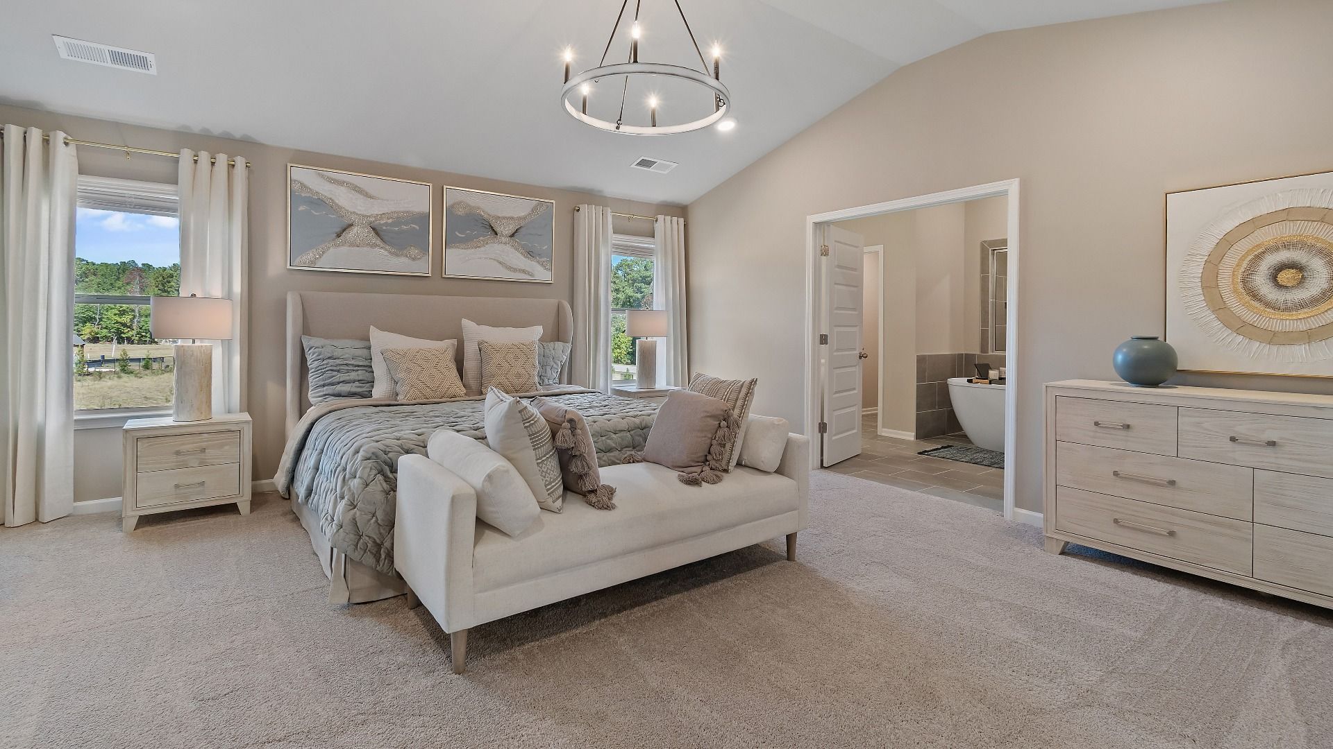 McKinley II primary suite with carpet flooring, natural light, and connected bath at Brighton in Locust Grove, GA.