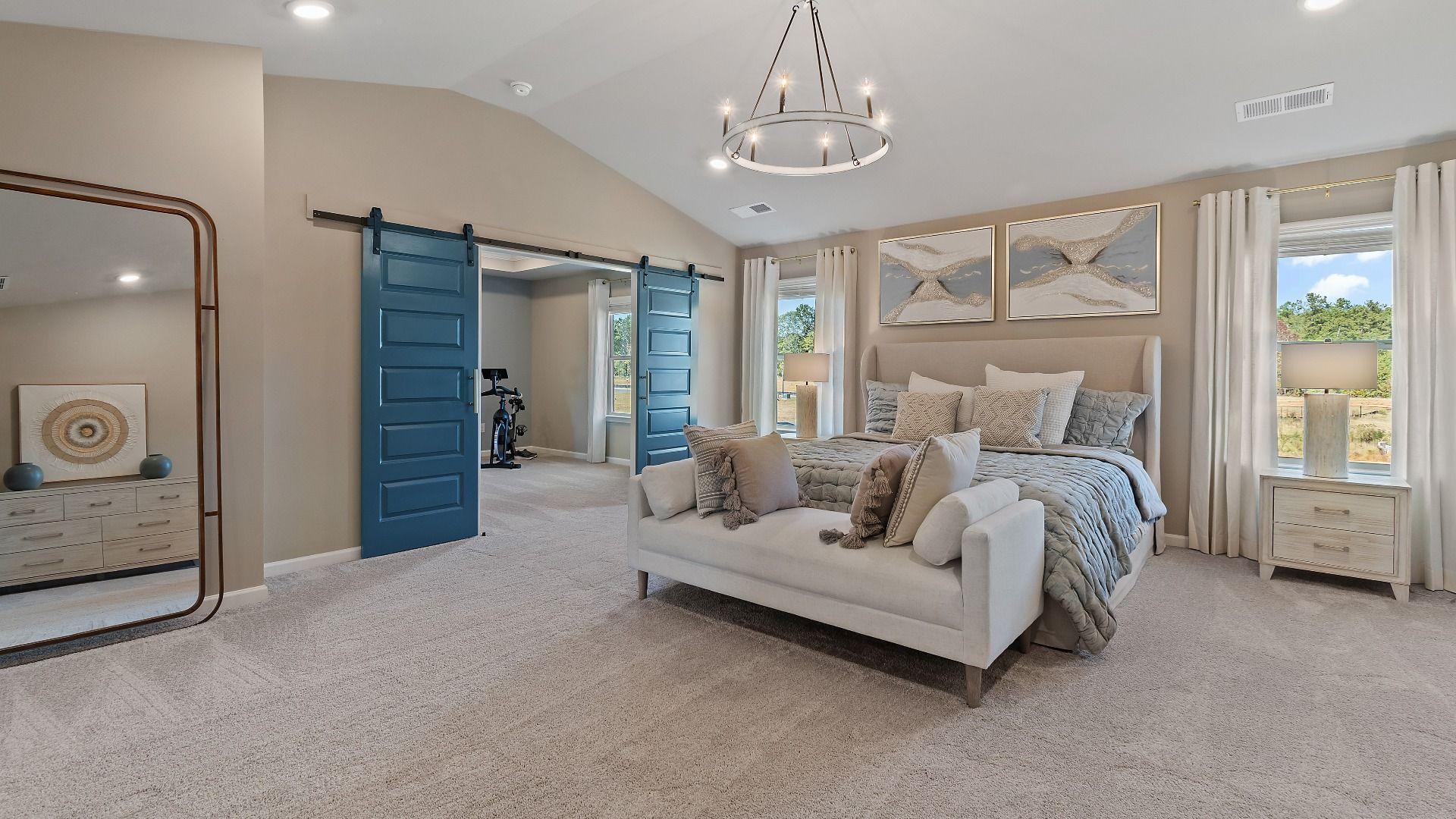 McKinley II resort-like primary suite with carpet flooring, natural light, and sitting room at Brighton in Locust Grove, GA.