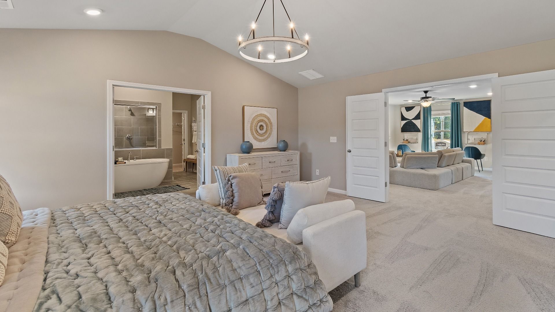 McKinley II primary suite with double-door entry, carpet flooring, and connected bath at Brighton in Locust Grove, GA.