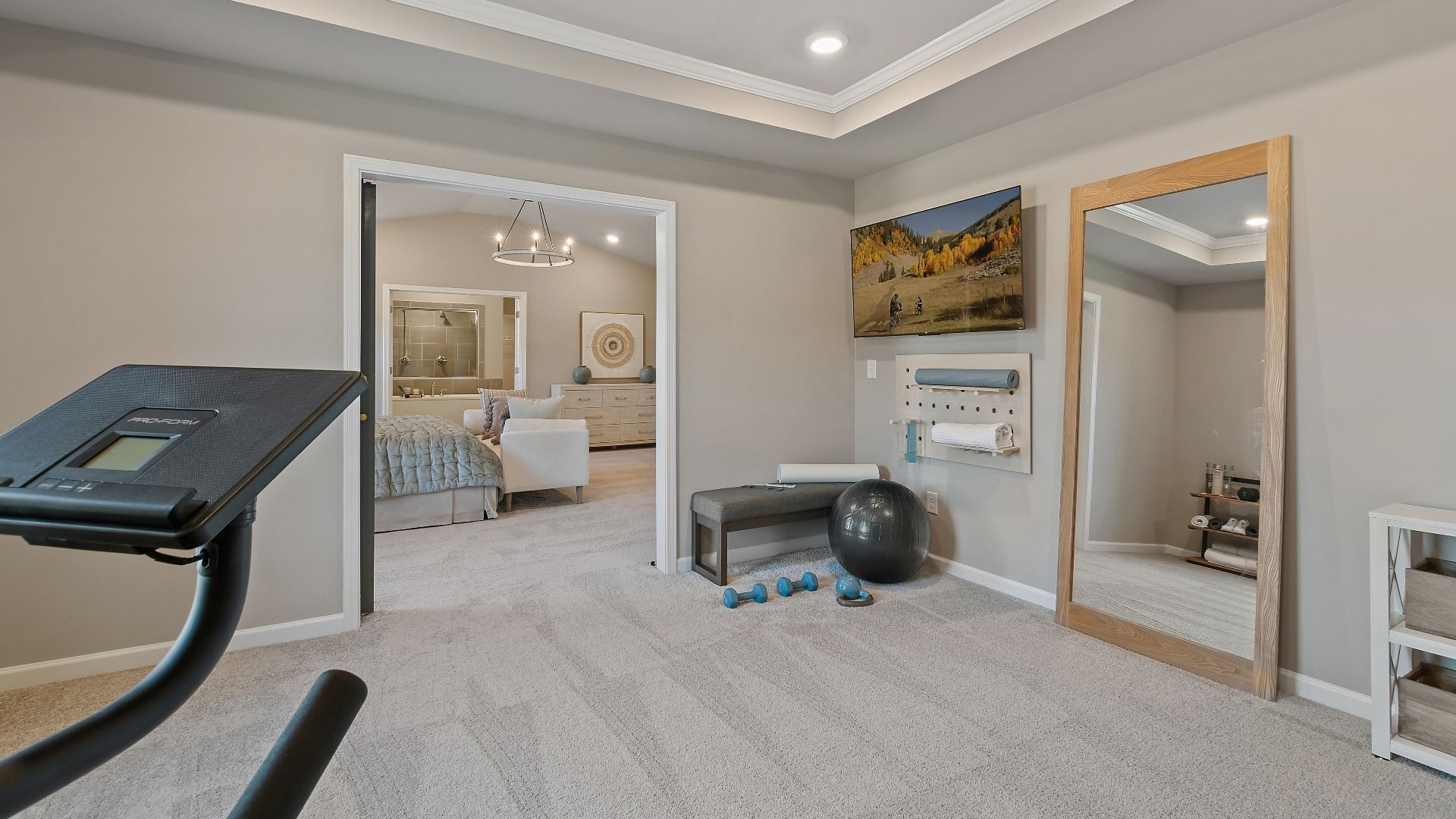 Primary suite sitting room for flexible use with tray ceiling and carpet flooring in the McKinley II at Brighton.
