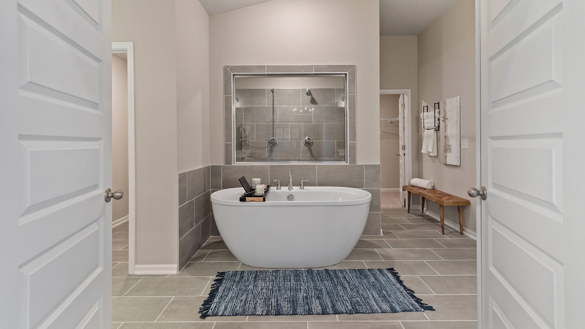 Modern primary bath with tile flooring and freestanding tub in the McKinley II at Brighton in Locust Grove, GA.
