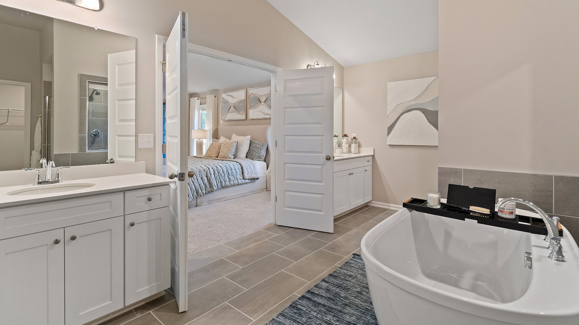 Primary bath with tile flooring, dual vanities, and freestanding tub in the McKinley II at Brighton in Locust Grove, GA.