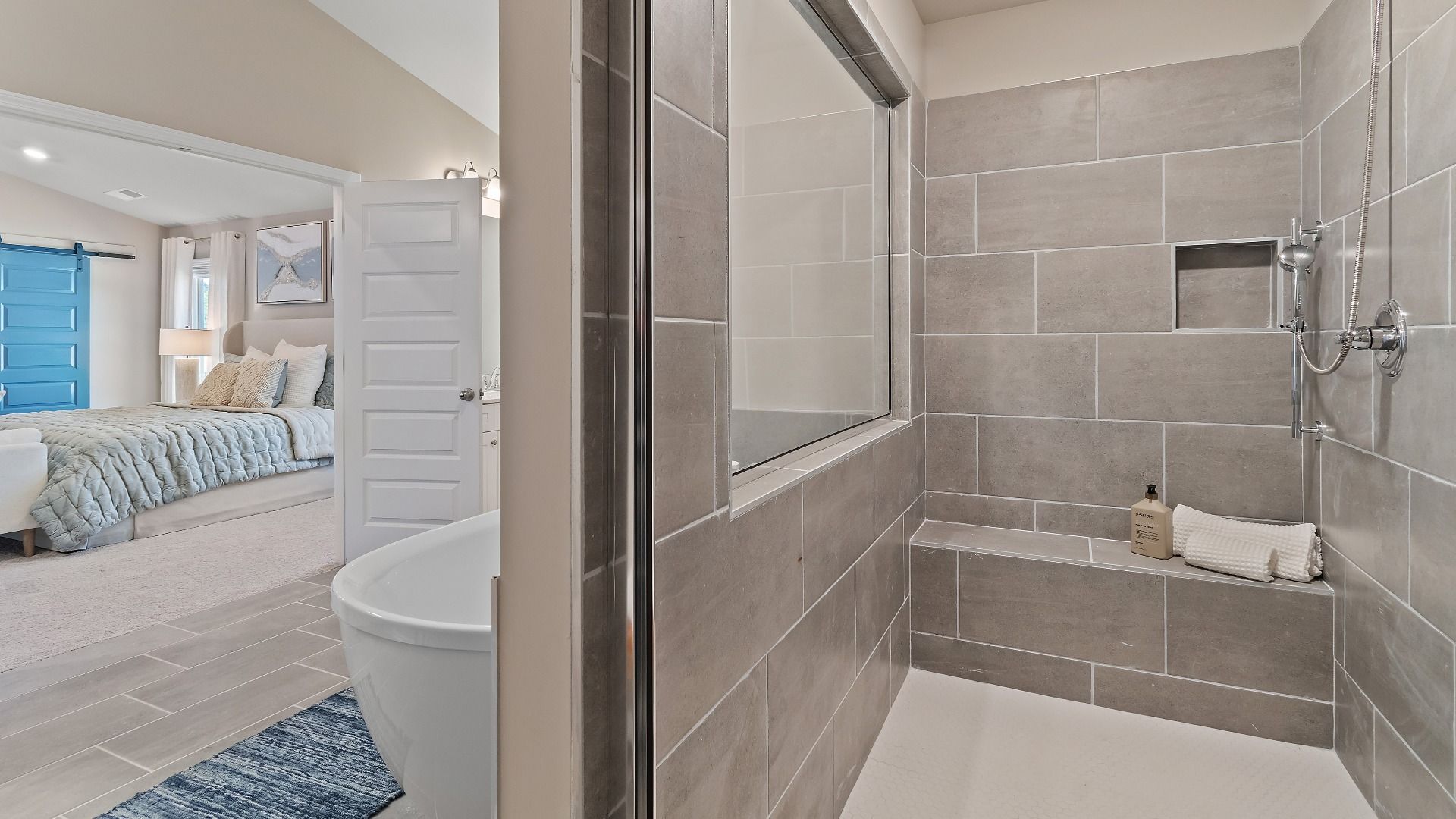 Primary bath with tile flooring, walk-in tile shower, freestanding tub in the McKinley II at Brighton in Locust Grove, GA.
