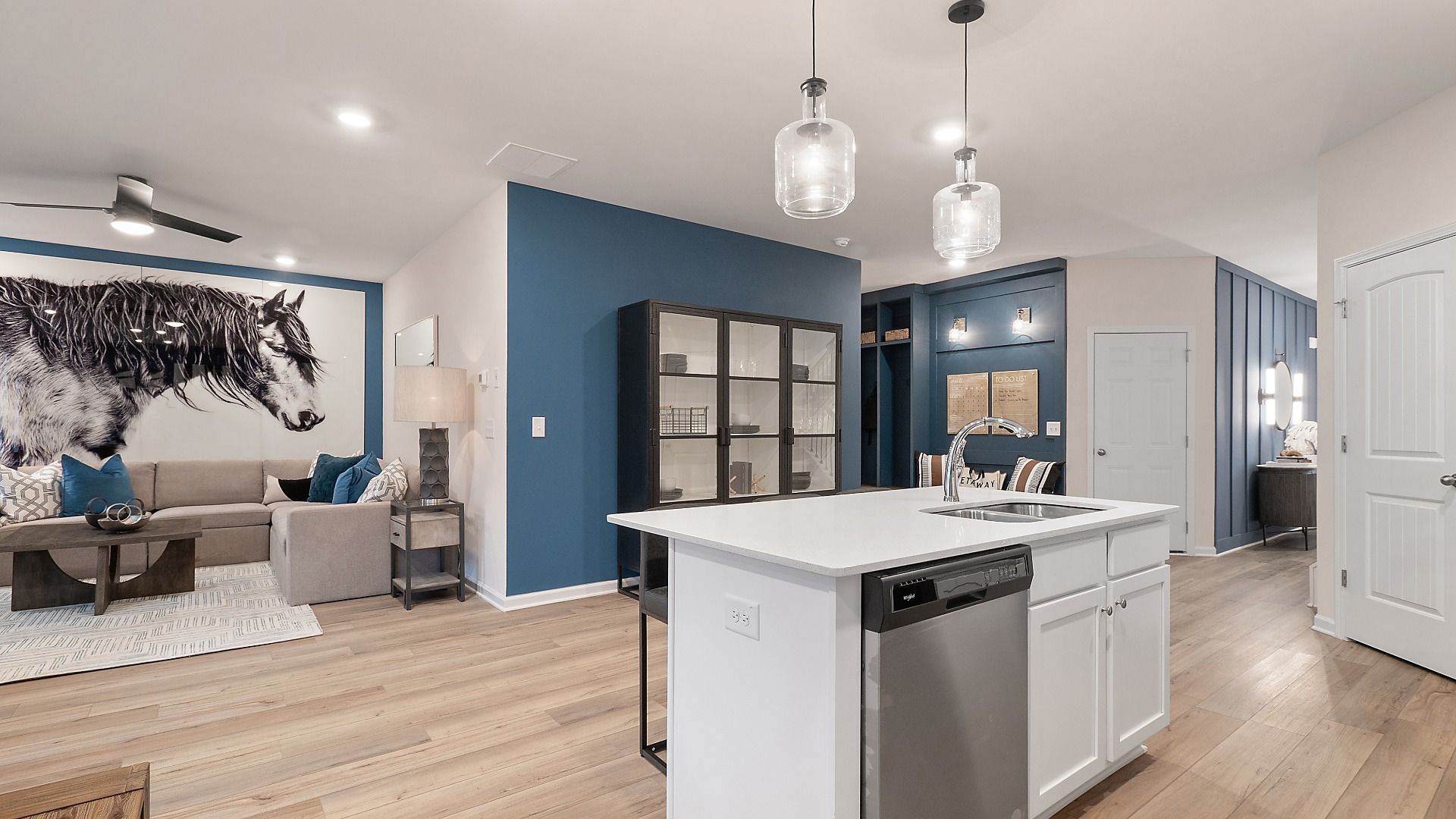 Zoey II kitchen with pendant lighting, white cabinetry, stainless appliances and center island at Abbotts Crossing.