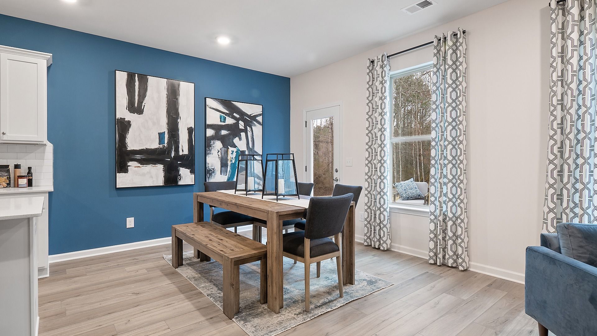 Zoey II breakfast area with view to kitchen and family room, featuring large window at Abbotts Crossing in Conyers, GA.