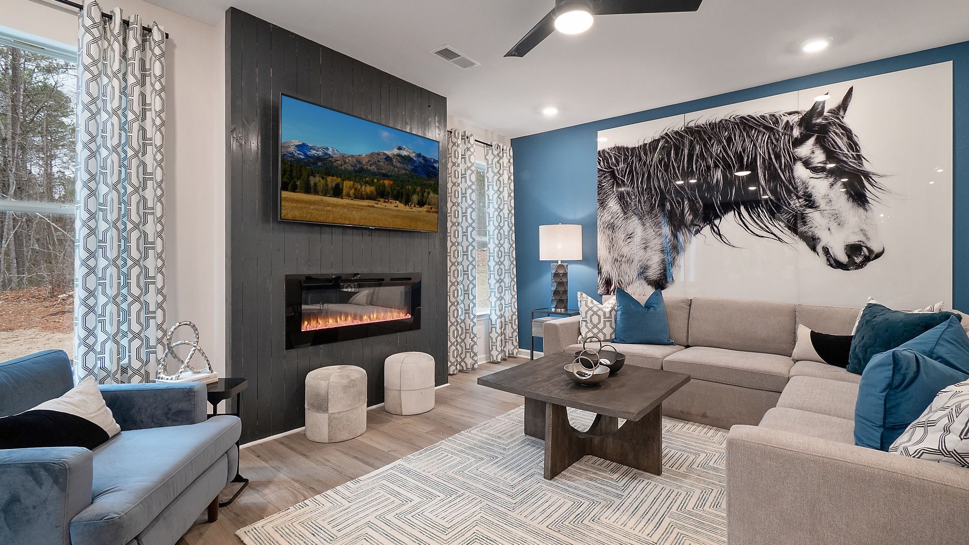 Zoey II family room with center gas fireplace, large windows, and ample seating at Abbotts Crossing in Conyers, GA.