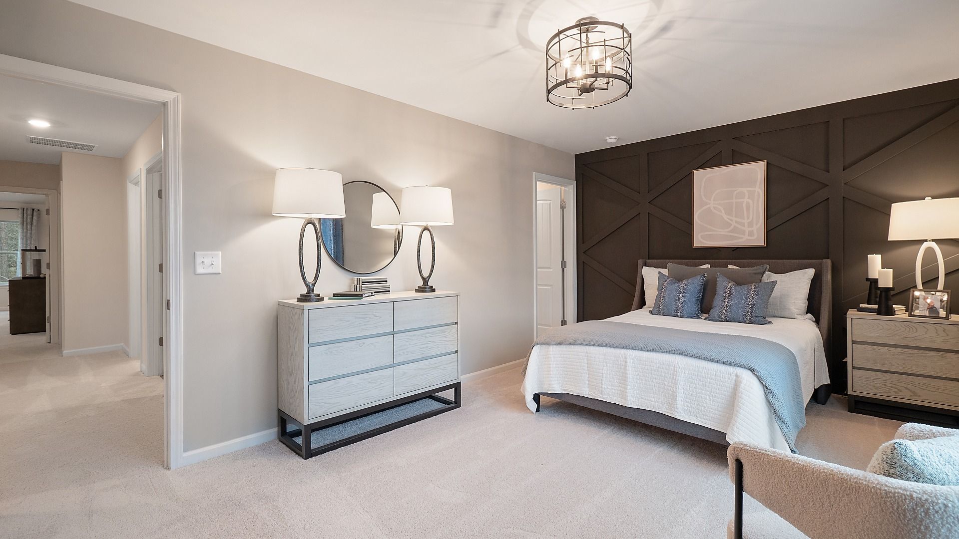 Spacious secondary bedroom with seating area, carpet flooring, and neutral finishes in the Zoey II plan at Abbotts Crossing.