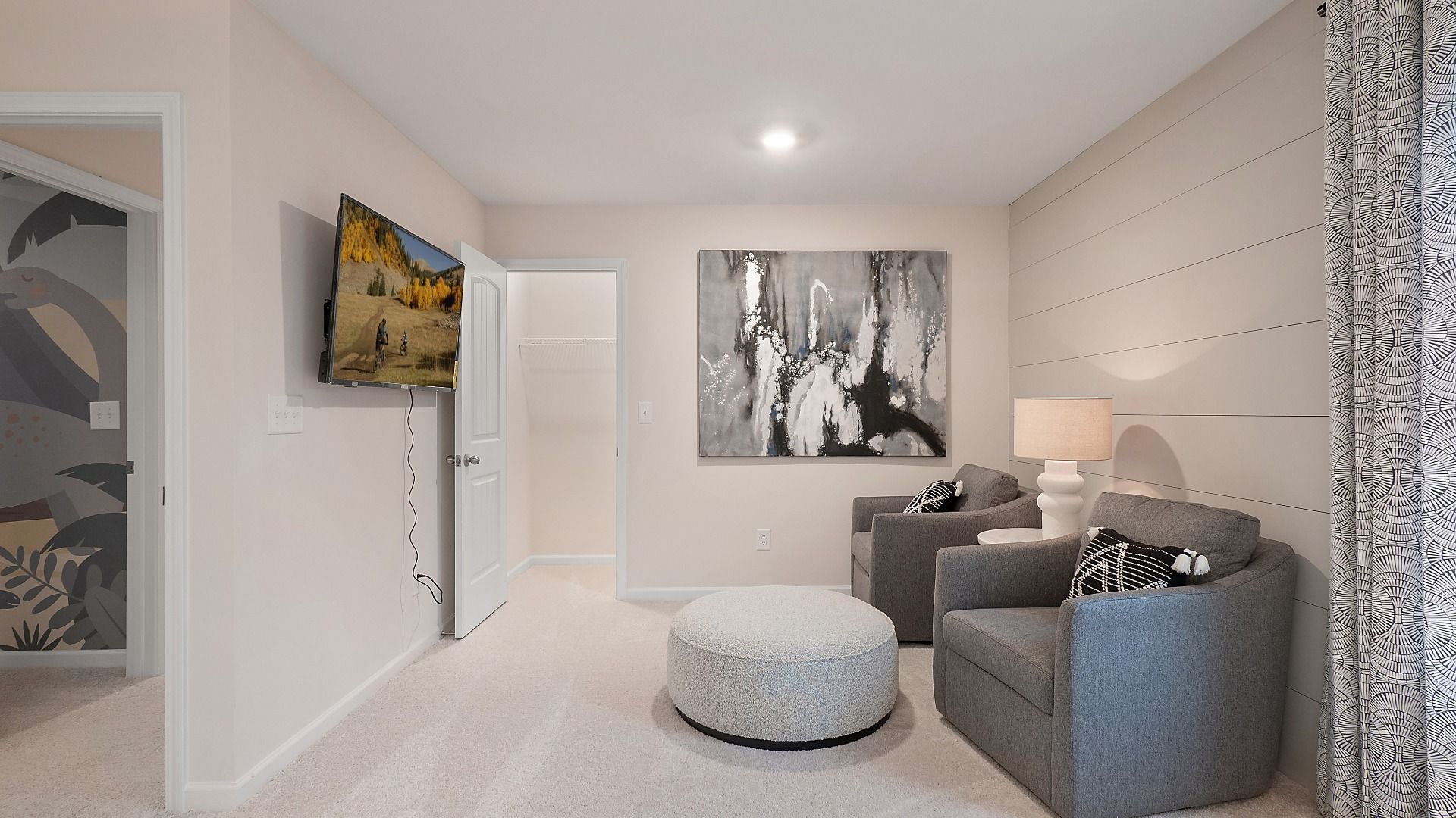 Primary suite sitting area with carpet flooring and neutral finishes in the Zoey II plan at Abbotts Crossing.