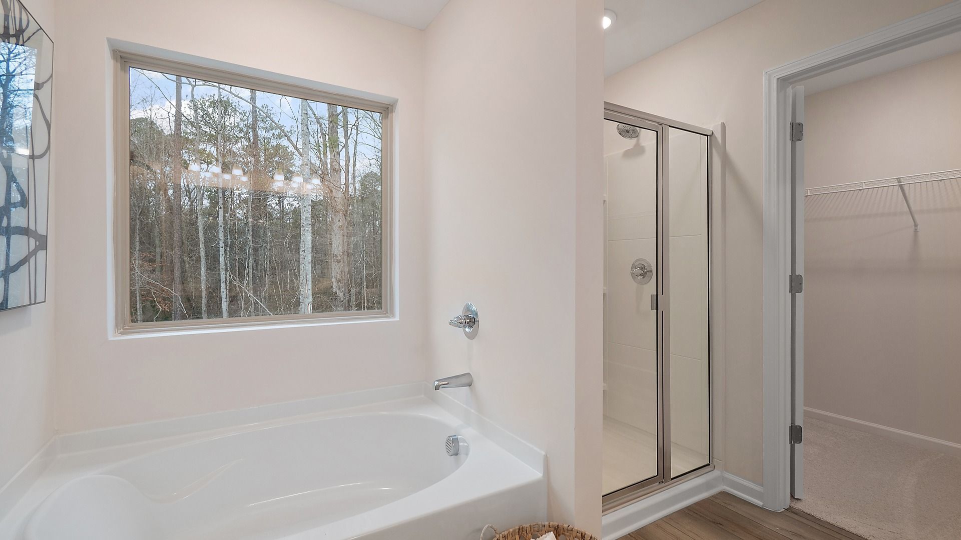 Primary bath with drop-in tub and walk-in shower in the Zoey II plan at Abbotts Crossing in Conyers, GA.