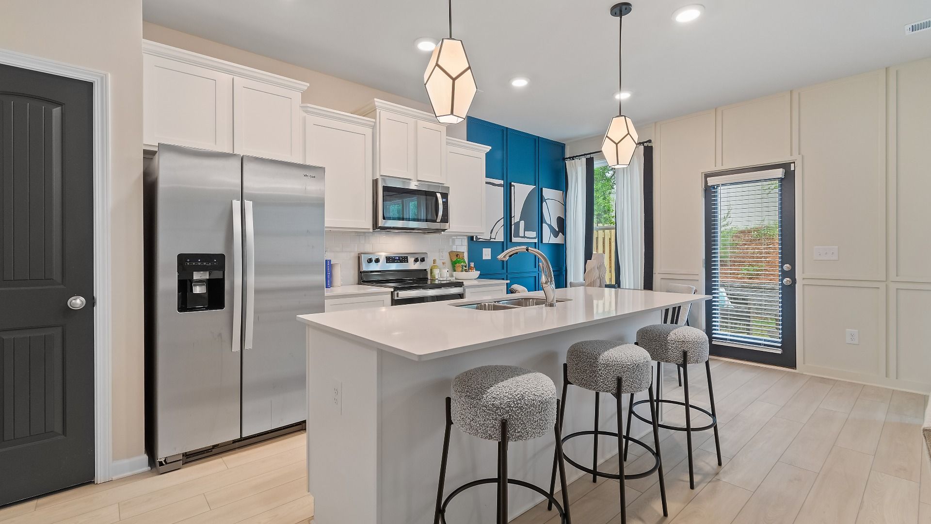 Modern kitchen with large island and stainless appliances at Avery Landing in McDonough, GA