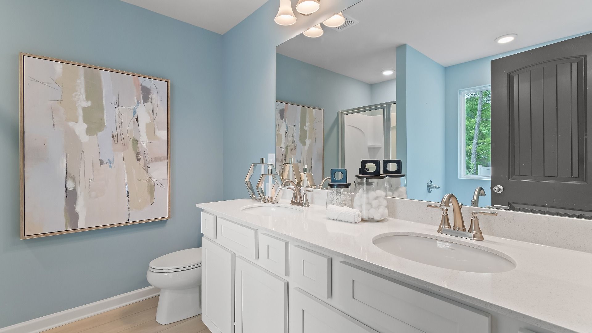 Primary bathroom with double vanity and shower in new construction townhome at Avery Landing in McDonough, GA