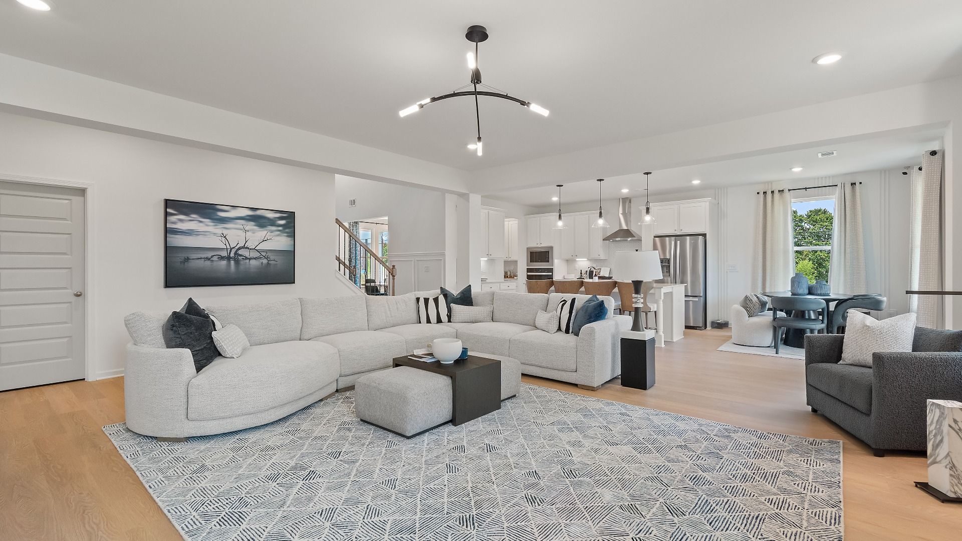 Bright family room in an open-concept layout at Grandview at Millers Mill in Stockbridge, GA.