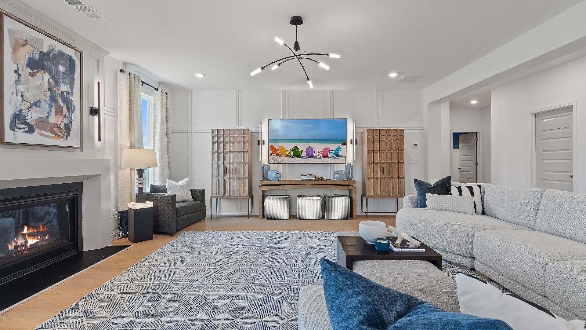 Spacious family room featuring a fireplace and large window at Grandview at Millers Mill in Stockbridge, GA.