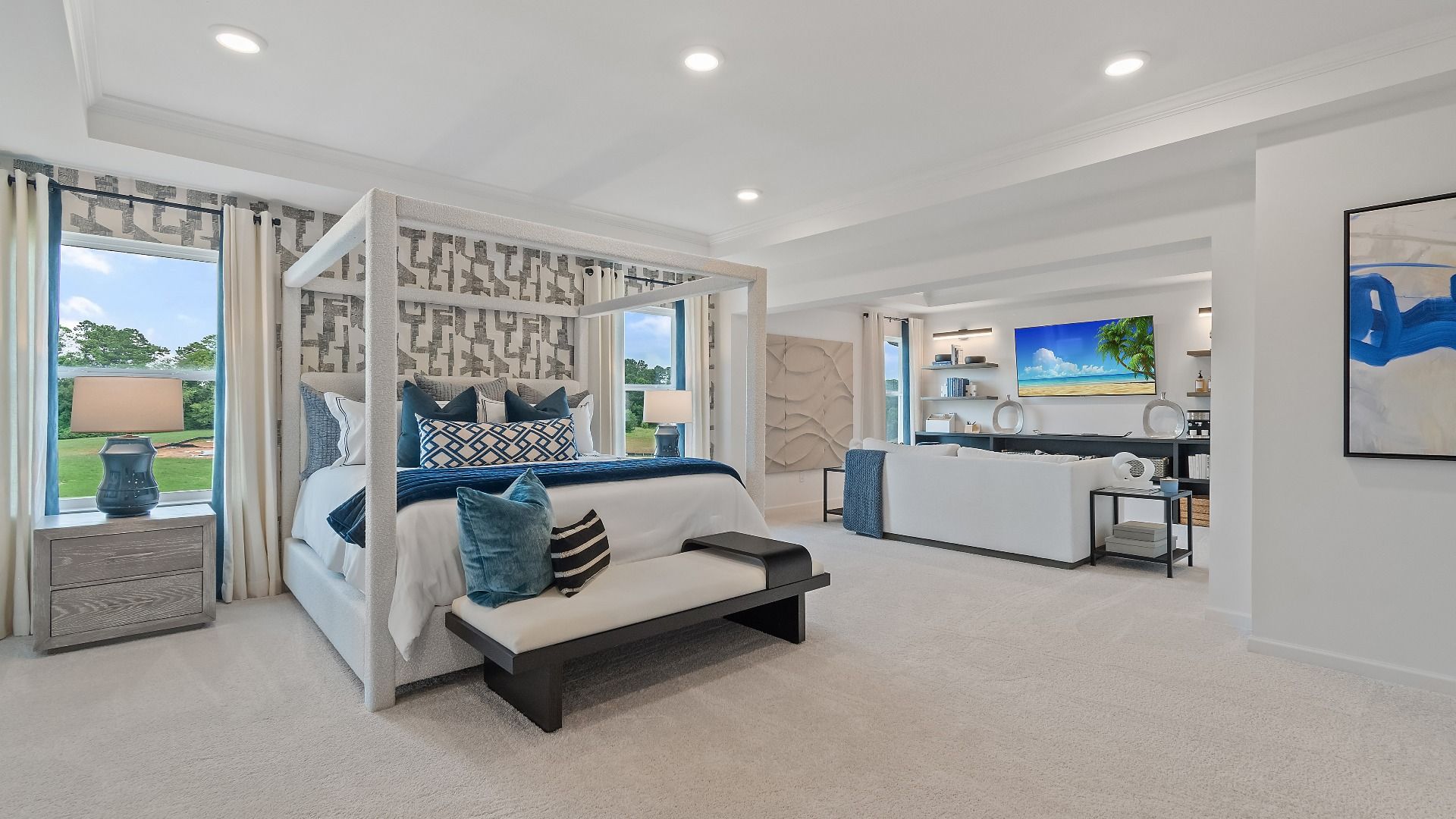 Spacious primary bedroom with sitting room, large windows, and tray ceiling at Grandview at Millers Mill in Stockbridge, GA.