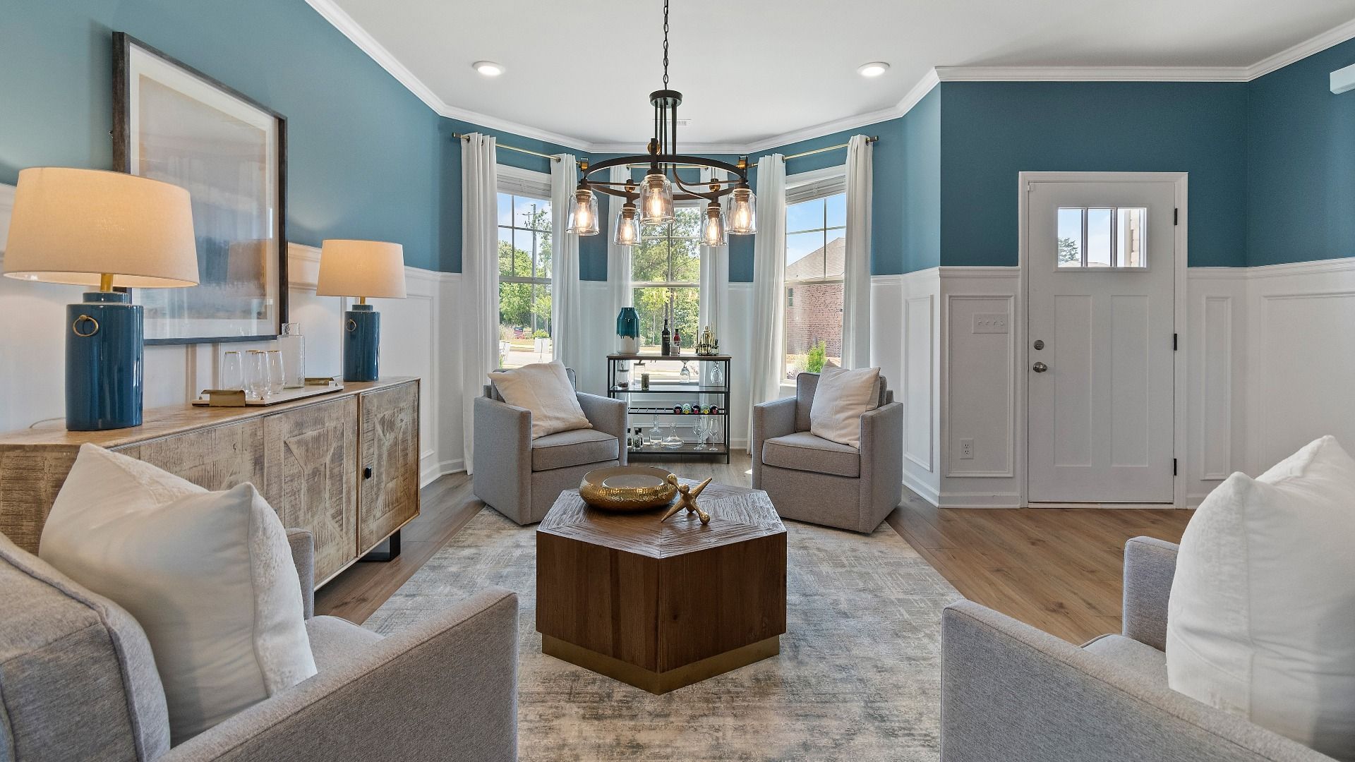 Everest III living room with ample seating area, LVP flooring, and modern finishes at Berkeley Lakes in Locust Grove, GA.