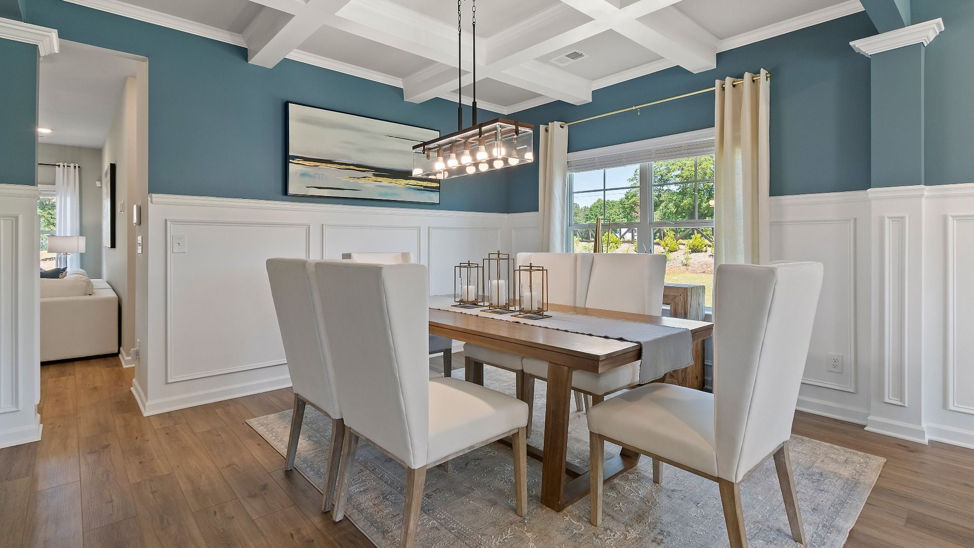 Everest III dining room with coffered ceiling, LVP flooring, and large window for natural light at Berkeley Lakes.