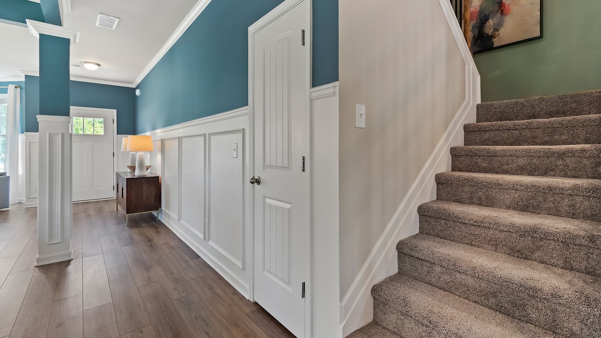 Open foyer with carpeted stairs in the Everest III new construction single-family home at Berkeley Lakes in Locust Grove, GA.