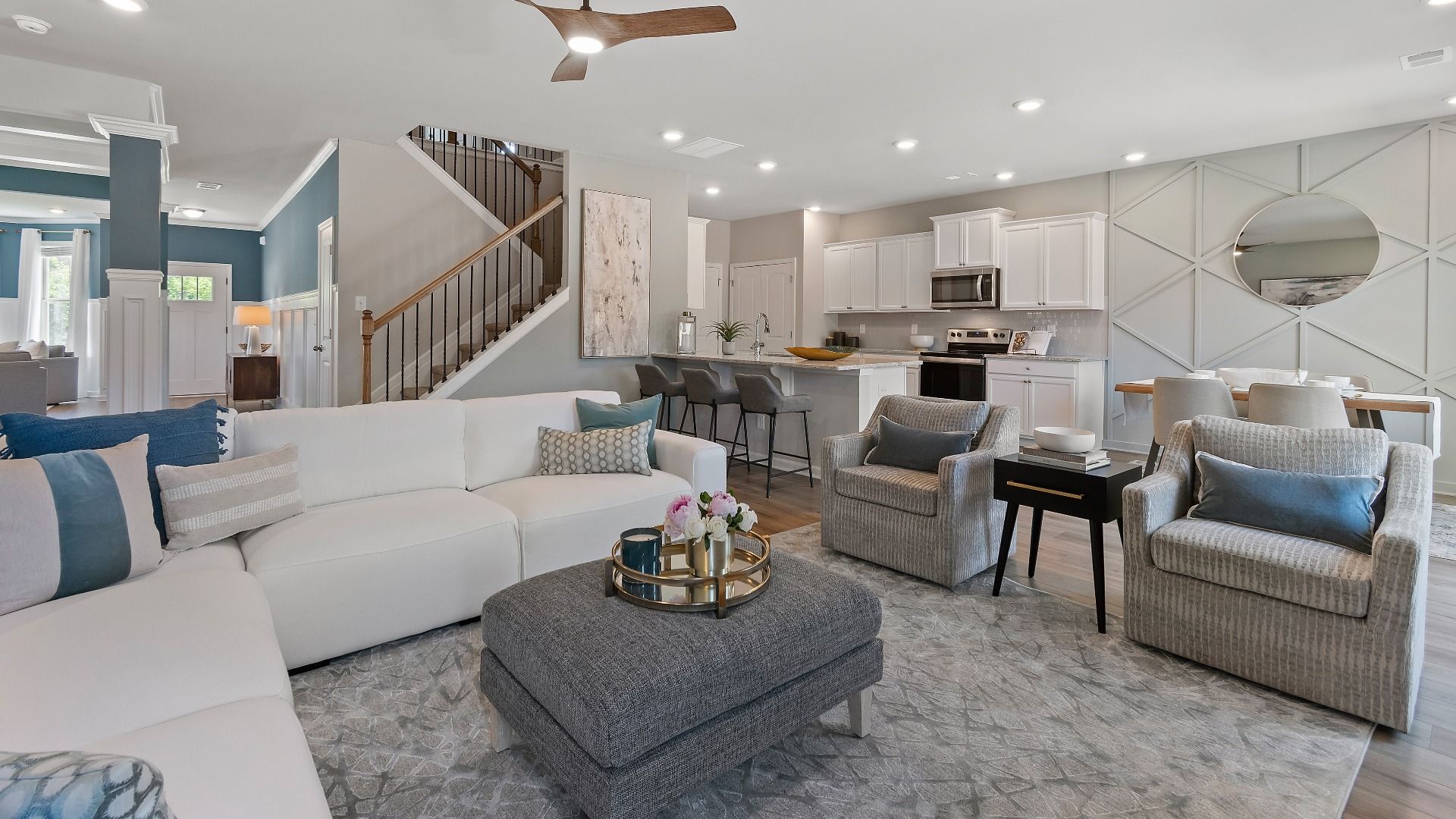 Open-concept modern family room with LVP flooring and clear connection to the kitchen in the Everest III at Berkeley Lakes.