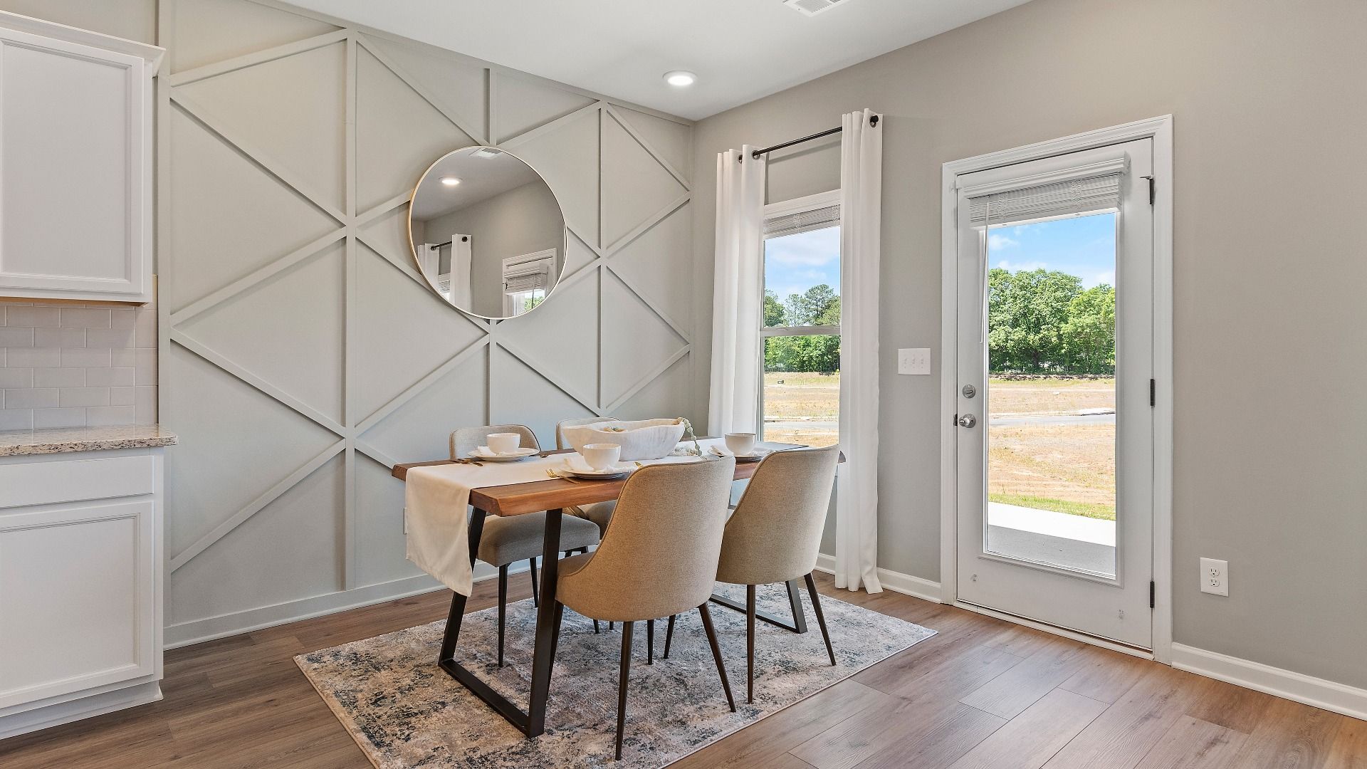 Breakfast area off the kitchen with LVP flooring, natural light, and backyard view in the Everest III at Berkeley Lakes.