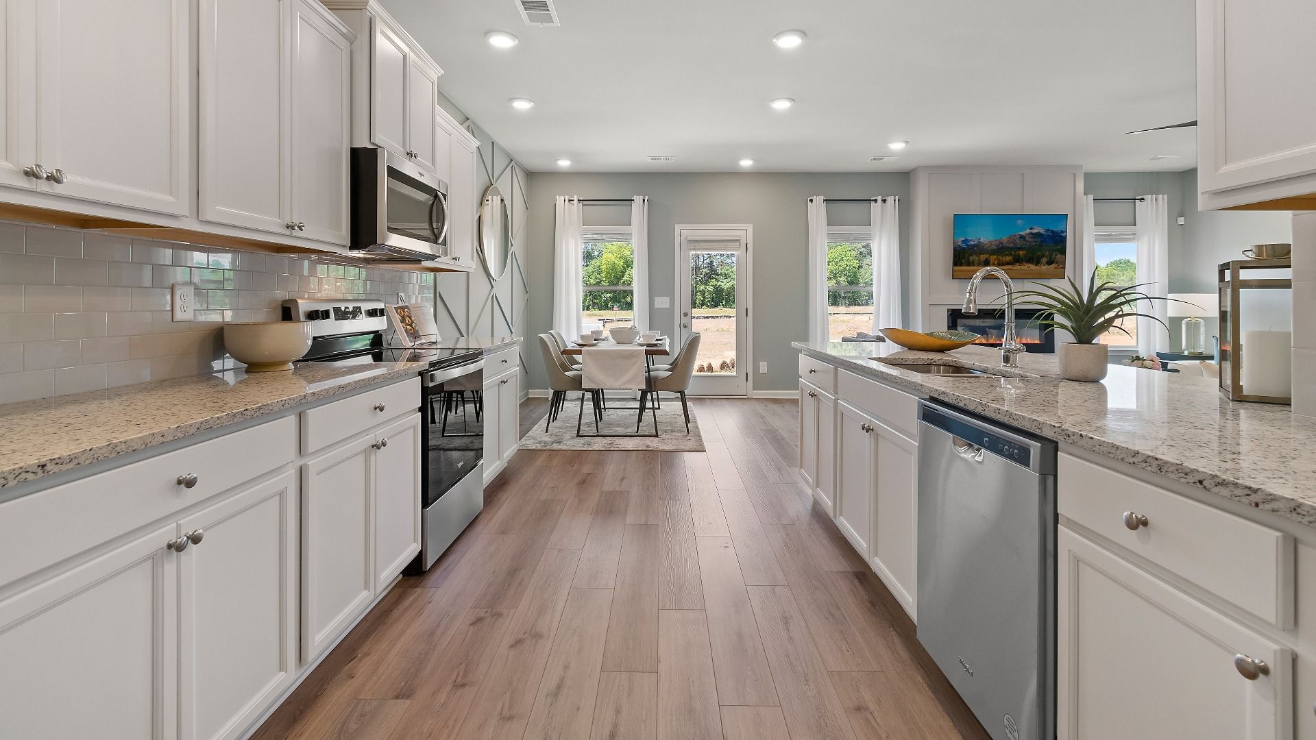 Everest III kitchen with white cabinetry, granite countertops, and stainless appliances at Berkeley Lakes in Locust Grove, GA