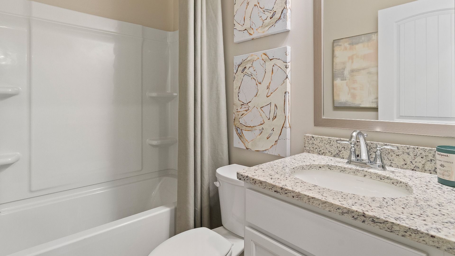 Bath with shower-tub combo and vanity featuring clean neutral finishes in the Everest III at Berkeley Lakes.