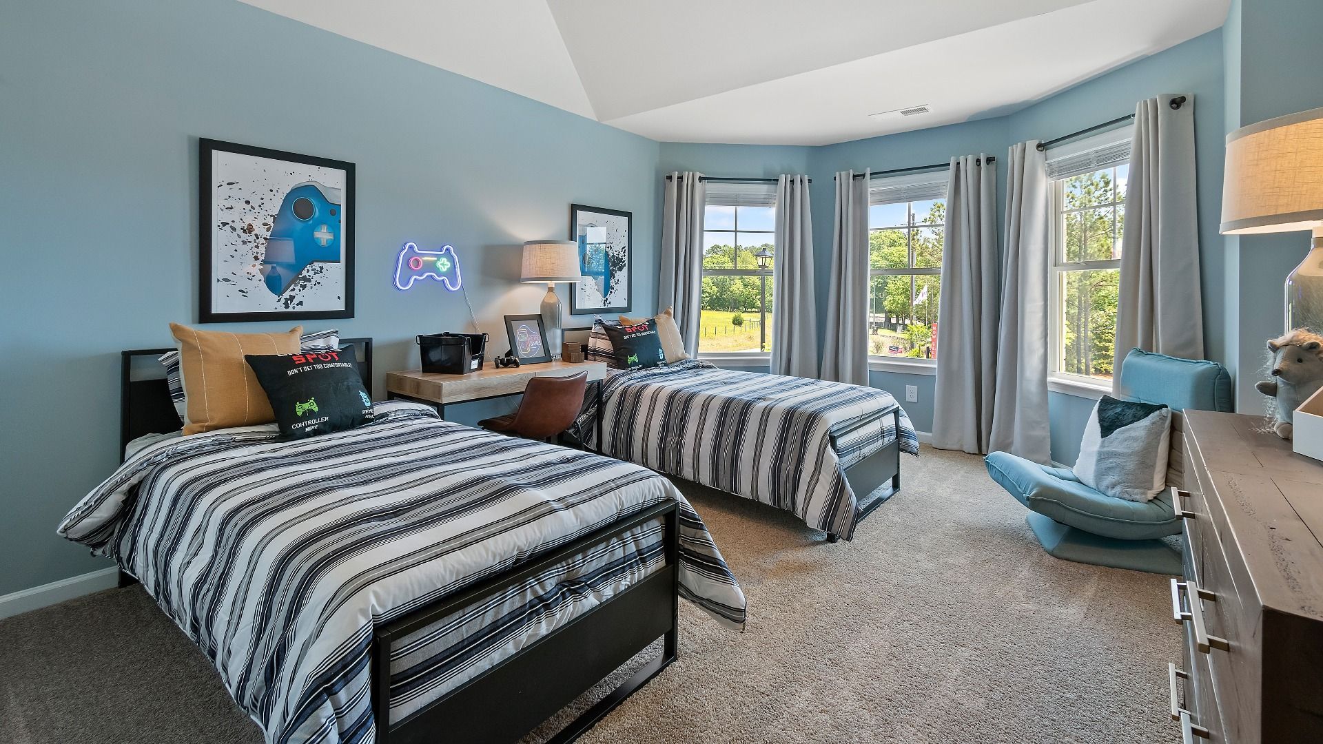 Spacious secondary bedroom with carpet flooring and abundant natural light in the Everest III at Berkeley Lakes.