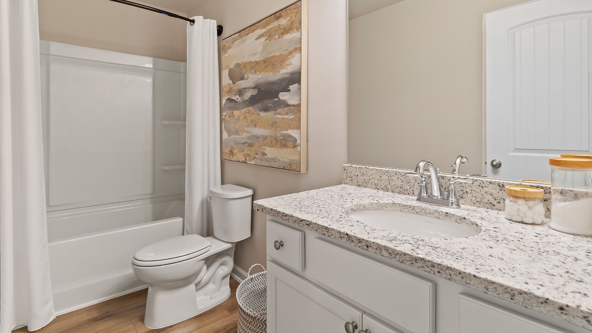 Secondary bath with shower-tub combo and vanity featuring LVP flooring in the Everest III at Berkeley Lakes.