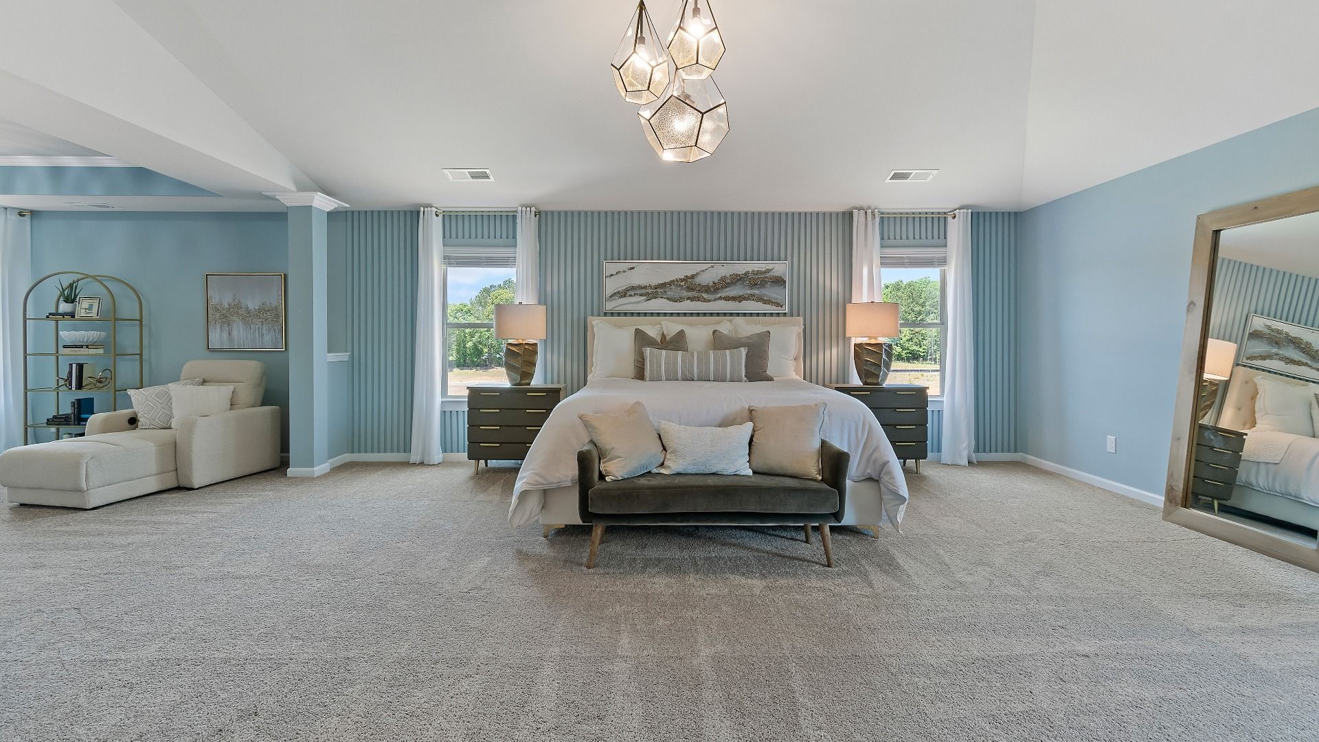 Expansive primary suite with carpet flooring, natural light, and room for seating in the Everest III at Berkeley Lakes.