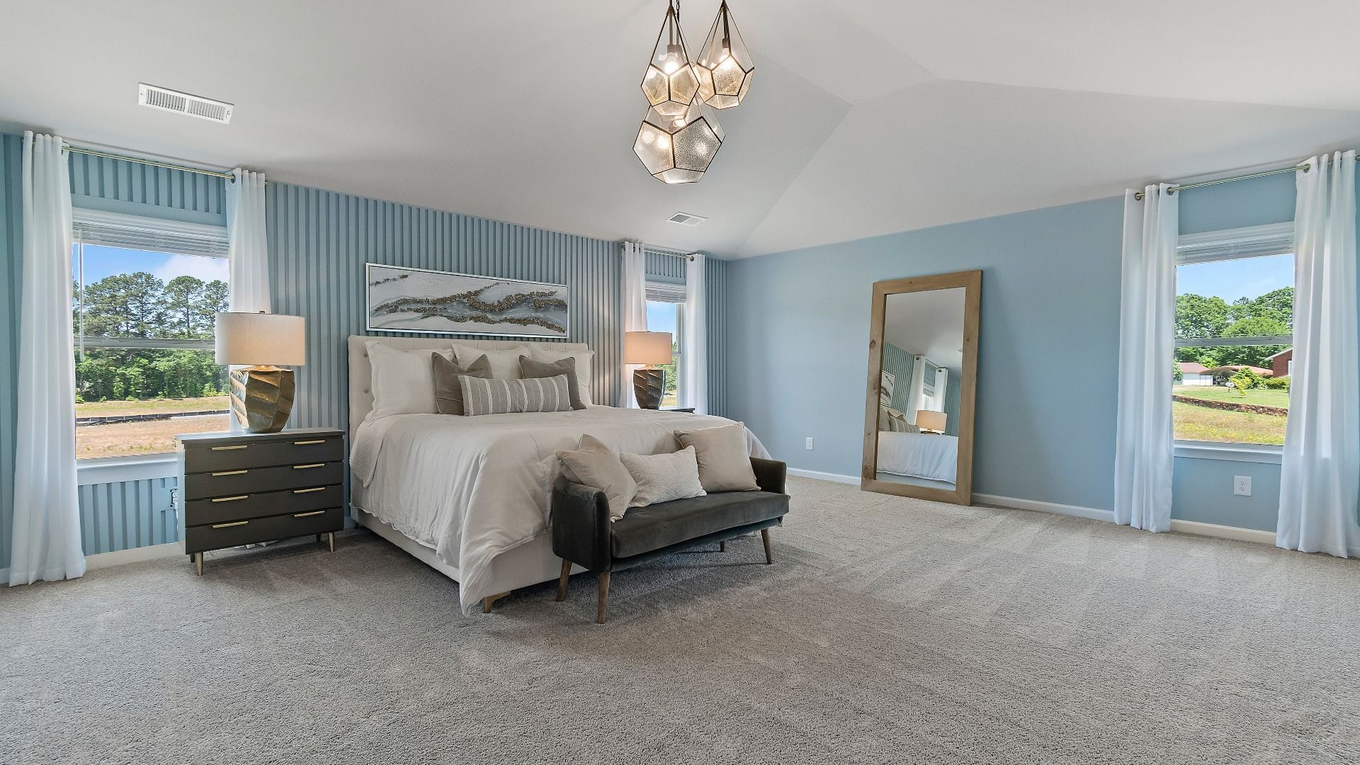 Expansive primary suite with carpet flooring, natural light, and room for seating in the Everest III at Berkeley Lakes.