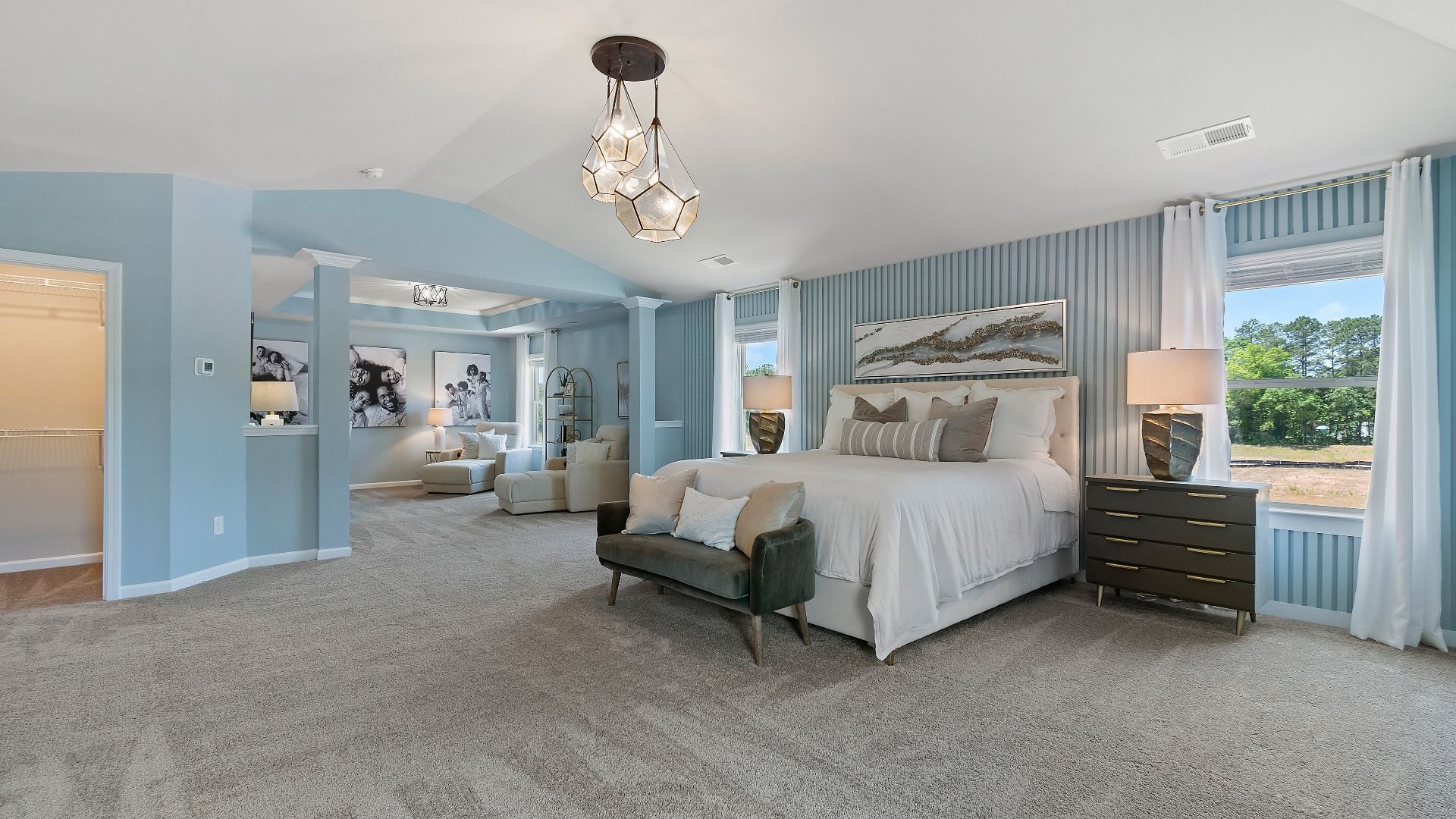 Expansive primary suite with carpet flooring, natural light, and room for seating in the Everest III at Berkeley Lakes.
