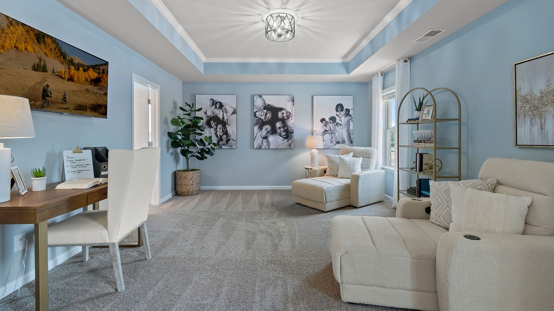 Primary suite sitting room with tray ceiling, carpet flooring, and natural light in the Everest III at Berkeley Lakes.