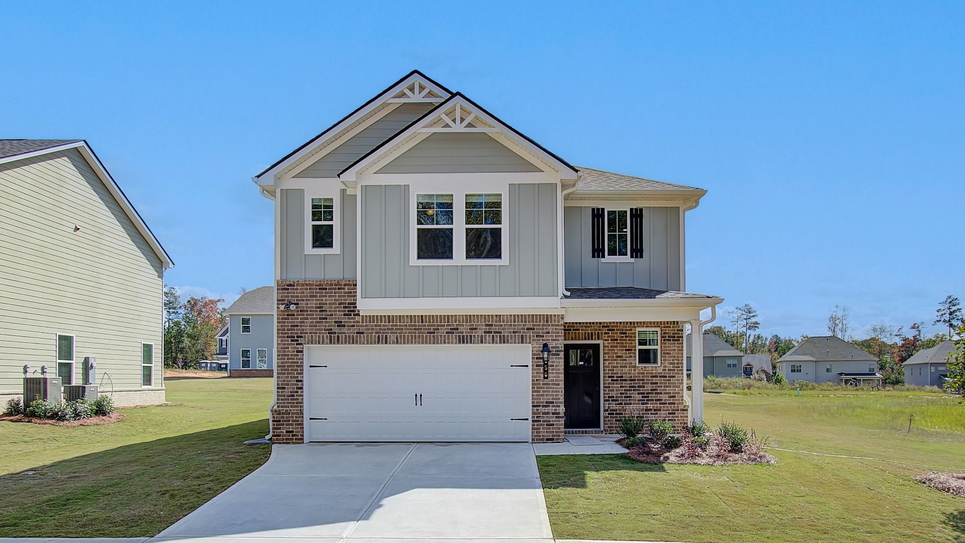 Reagan new construction single family home with two-story floorplan and front-entry garage at Westminster in Covington, GA.
