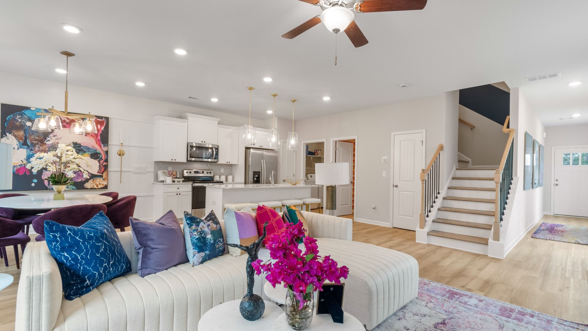 Spacious living area with an open, connected layout and modern finishes in a new construction townhome in Stockbridge, GA.