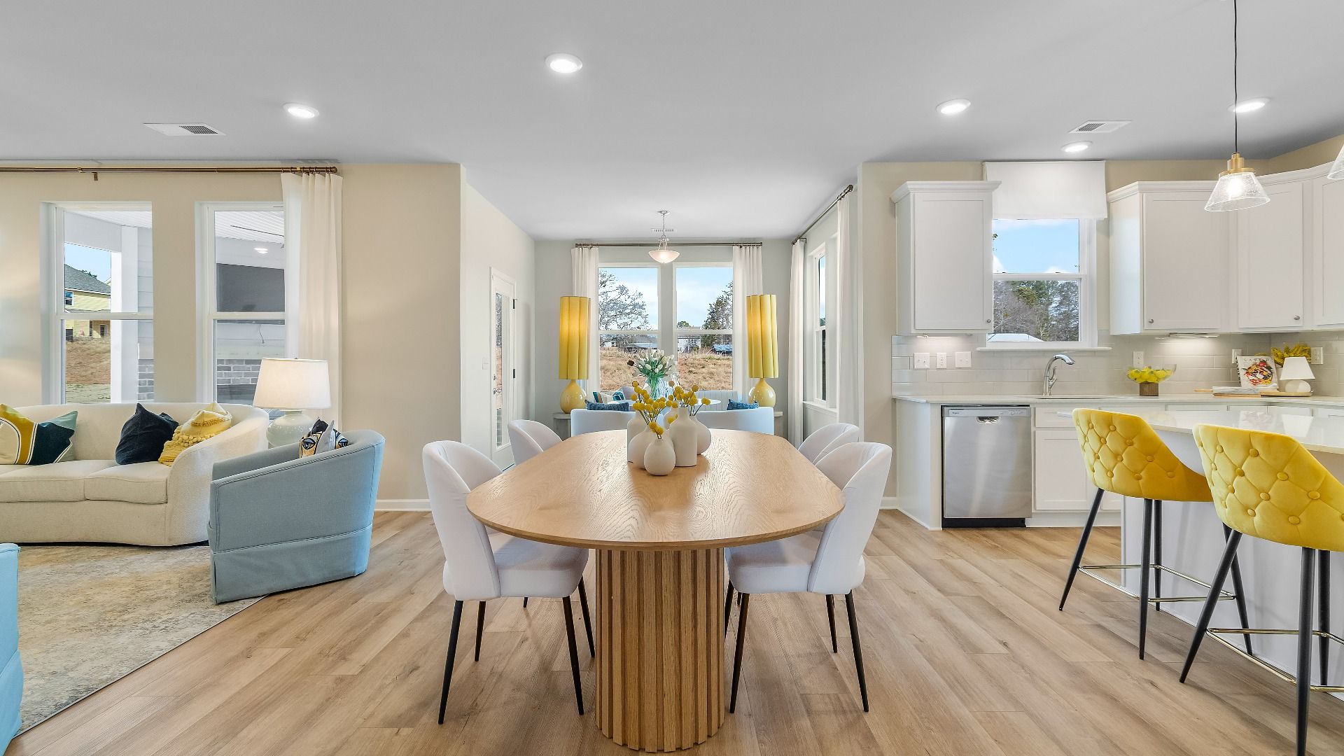 Bright open-concept breakfast area with seamless flow into kitchen and family room at Cooper Park in McDonough, GA.
