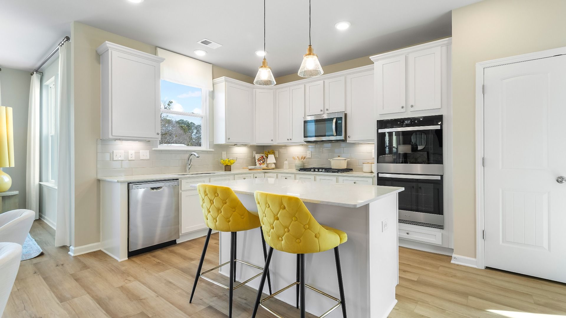 Modern kitchen with island and pendant lighting at Cooper Park in McDonough, GA.
